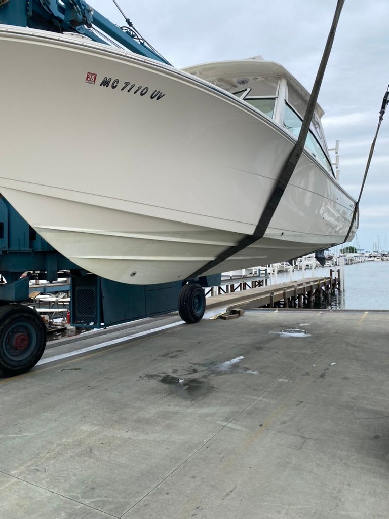 2023 Cobia 330 boat being lifted from the water.