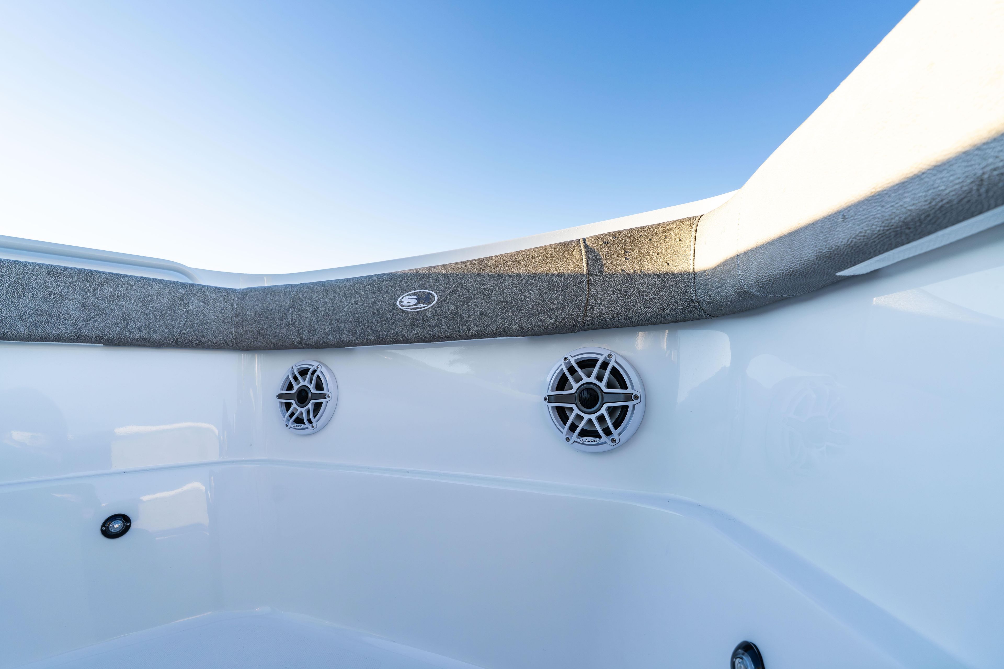 2026 Sea Hunt Ultra 275 Coffin Box boat interior with speakers and cushioned seating.