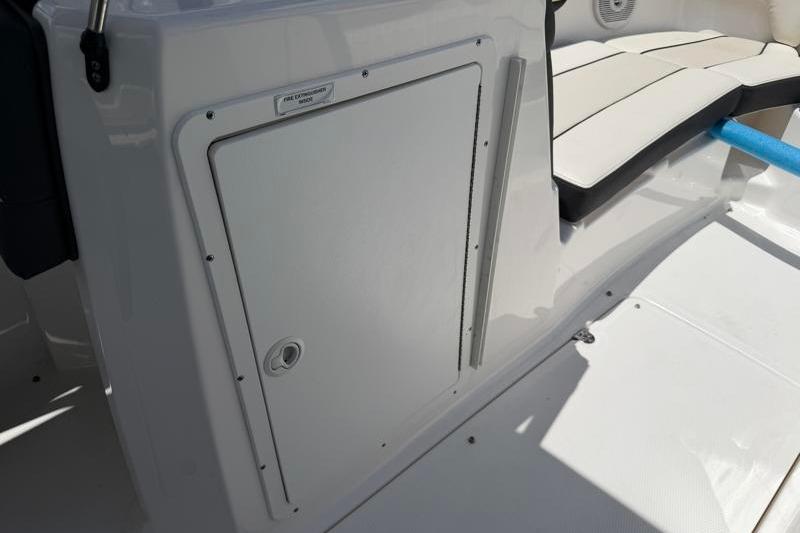 2017 Yamaha Boats SX210 interior with storage compartment and seating area.