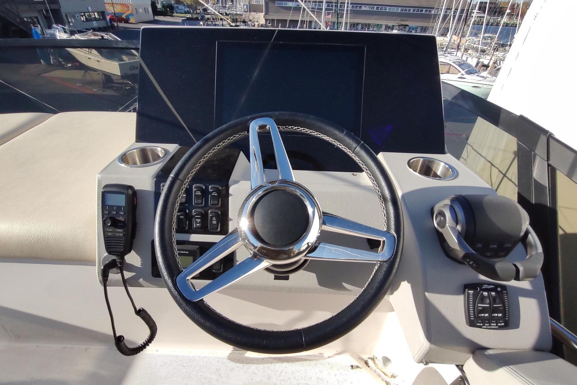 Helm of 2021 Regal 42 Fly yacht with steering wheel and controls.