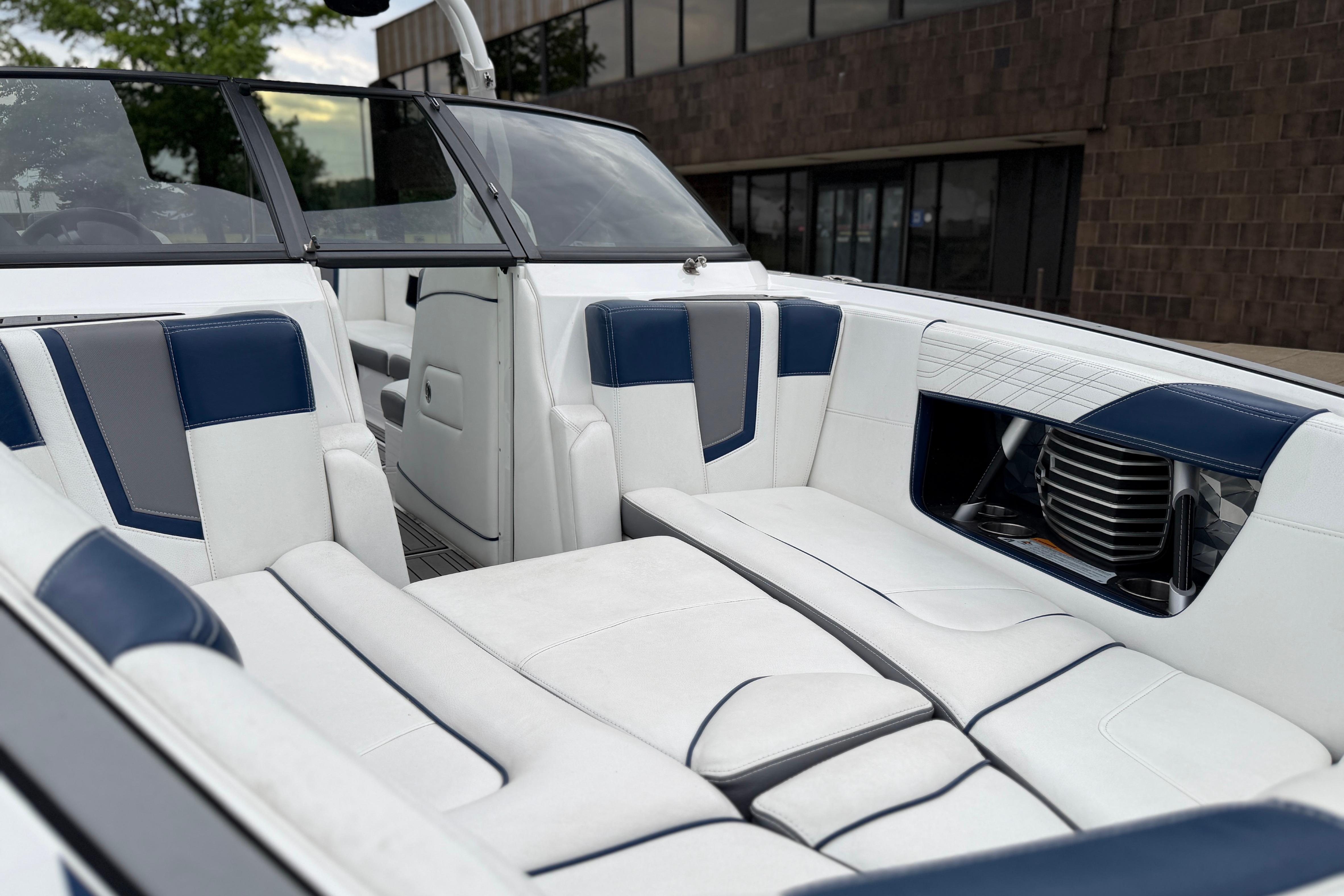 Interior of a 2016 Naitique G25 boat with white and blue seating.