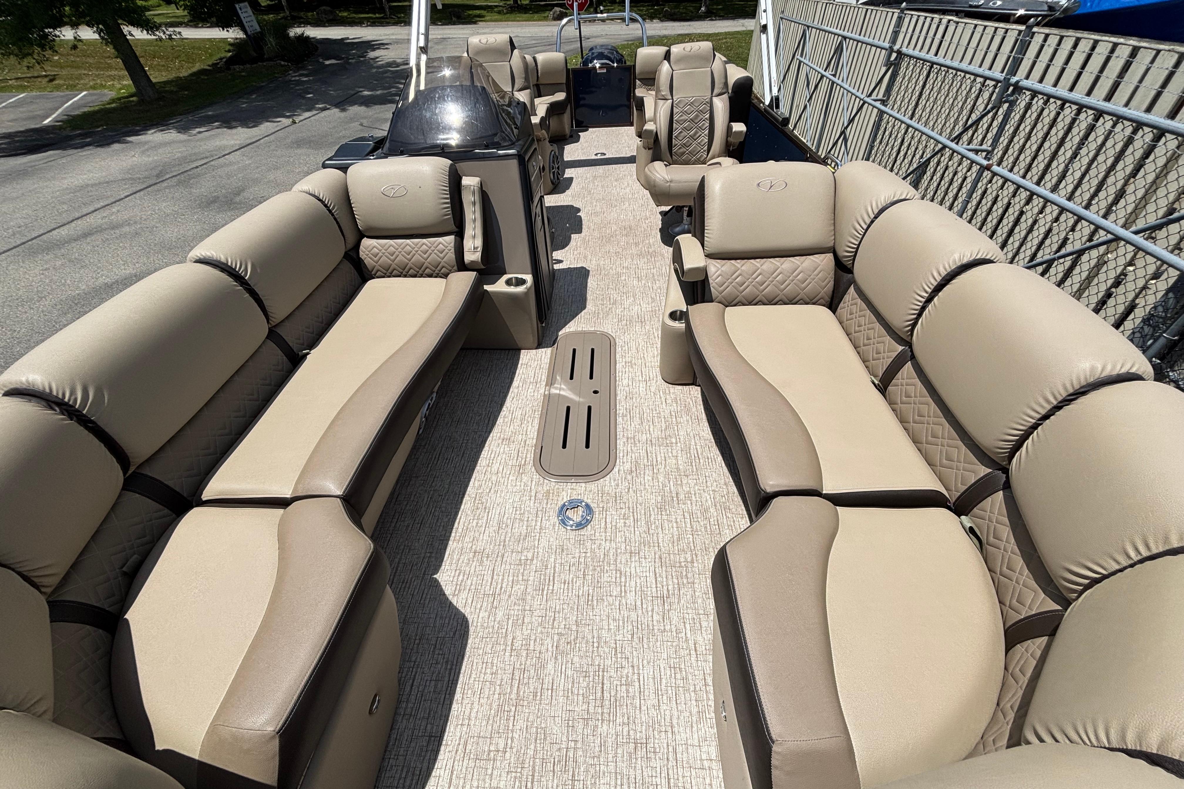 Luxurious 2021 Veranda VP25RC pontoon boat interior with plush beige seating and spacious layout.