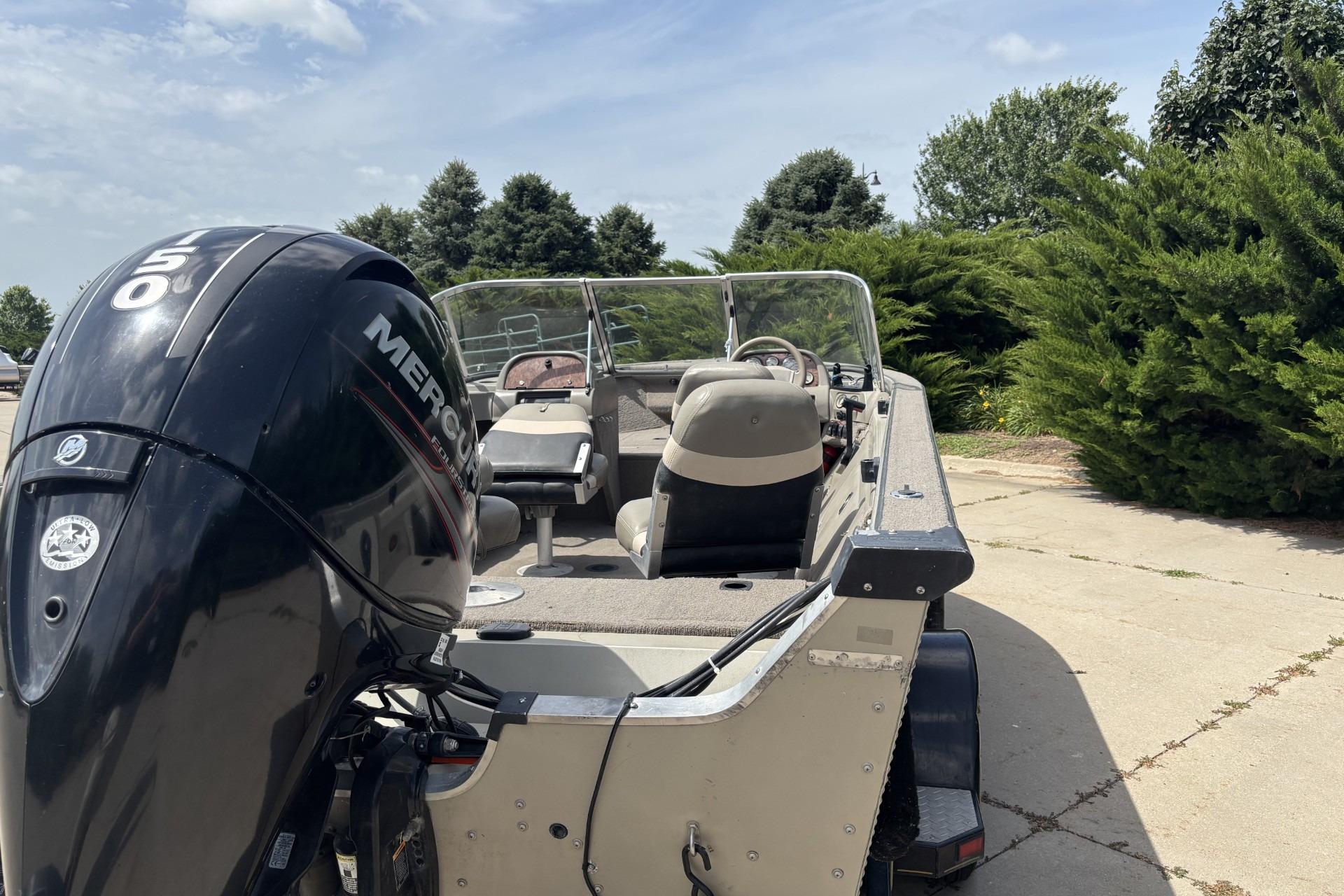 1999 Tracker Targa 18 boat with Mercury 150 outboard motor on a sunny day.