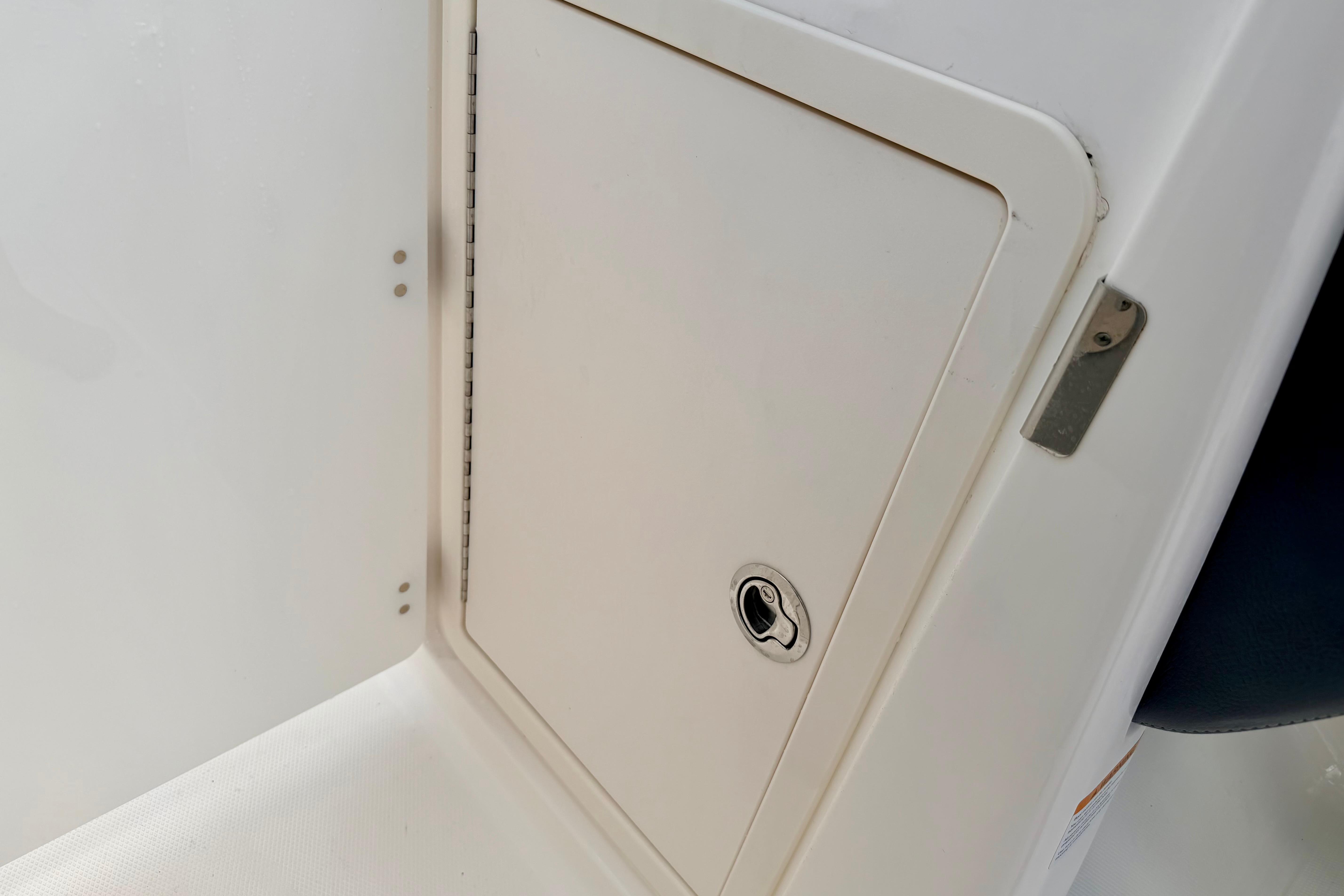 2015 Chaparral Sunesta 264 storage compartment with secure latch and sleek design.