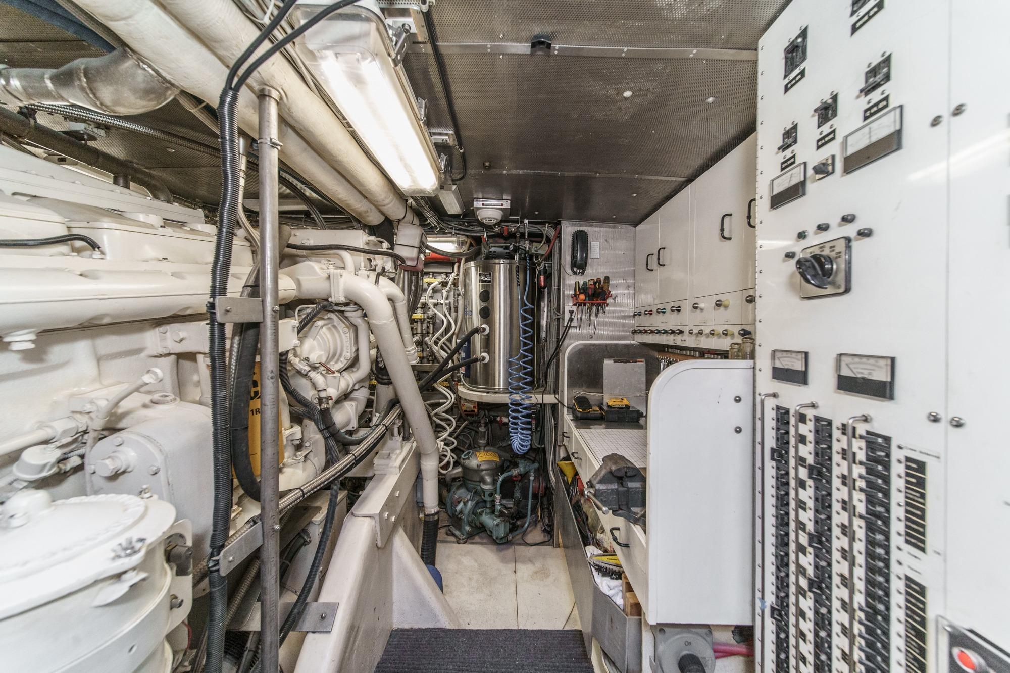 Engine room of a 1990 Seaton Long Range Cruiser, featuring complex machinery and control panels.