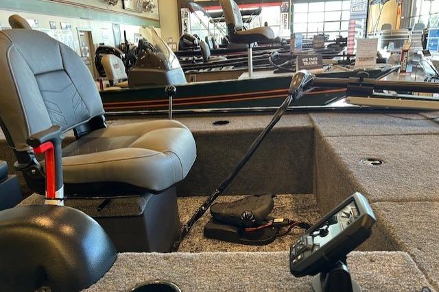 2025 Tracker Panfish 17 boat interior with seating and control panel in showroom.