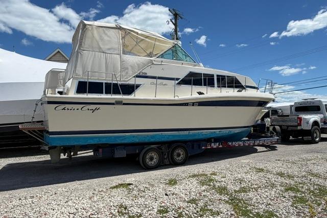 1980 Chris-Craft 381 Catalina boat on trailer under clear blue sky.