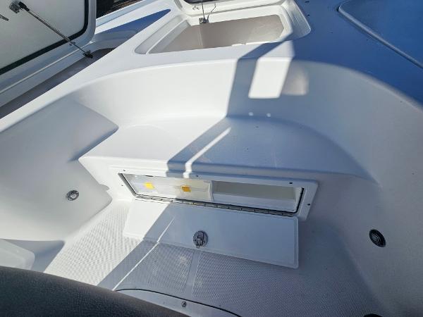 2026 Sea Hunt BX 22 BR boat interior with storage compartments and seating area.