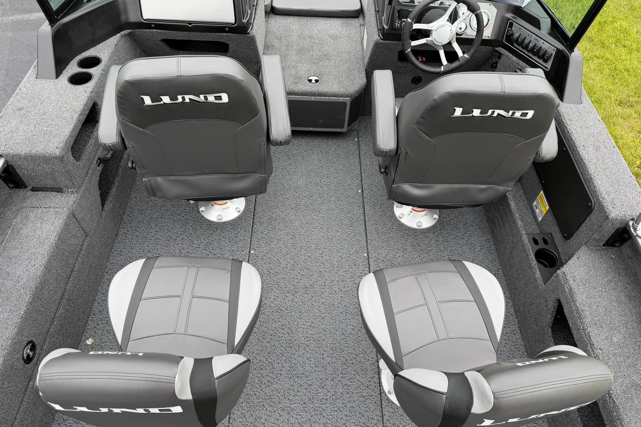 Interior of 2027 Lund 2075 Impact XS boat with four cushioned seats.