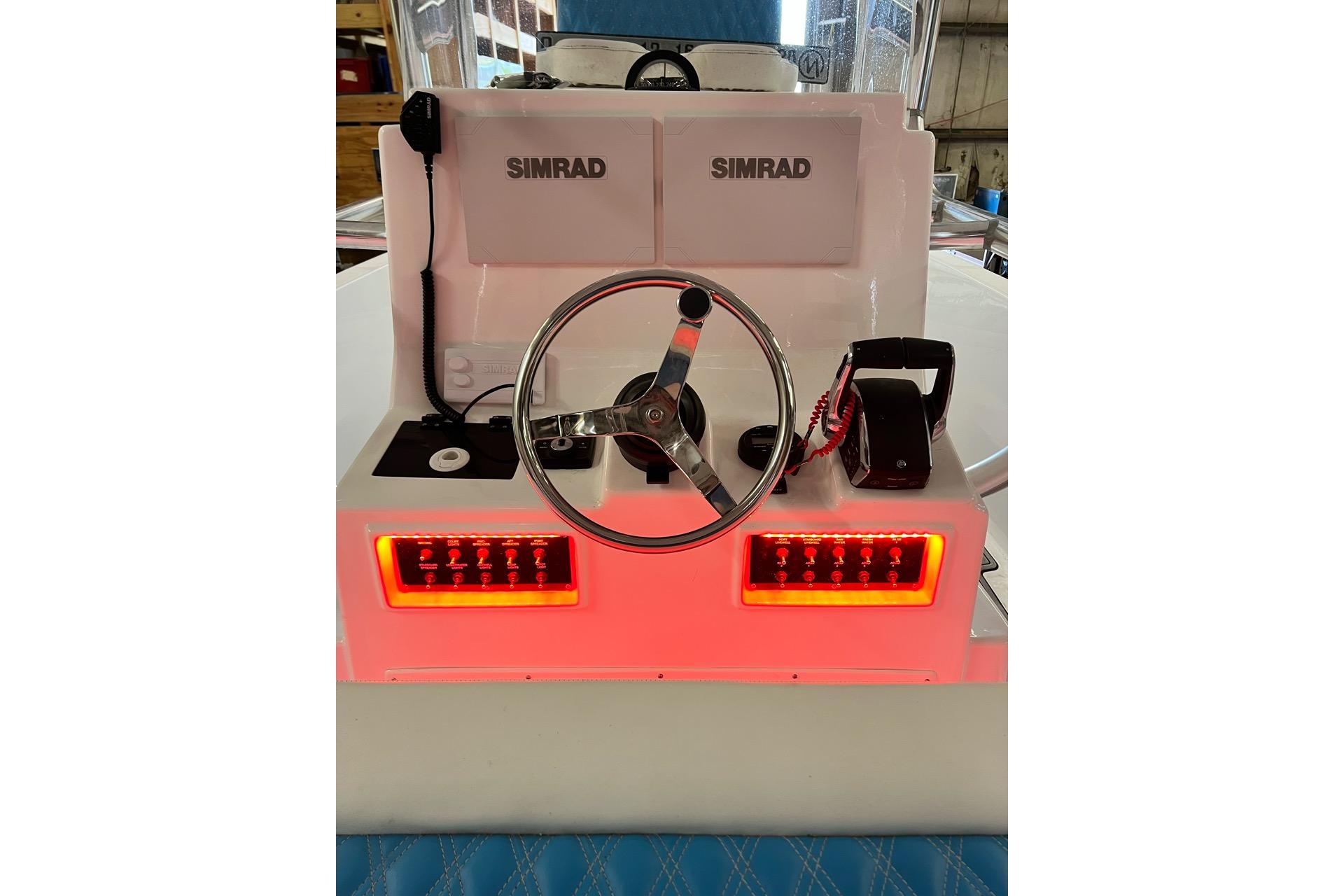Center console of 2021 Custom Infusion 34 CC boat with Simrad electronics and illuminated controls.