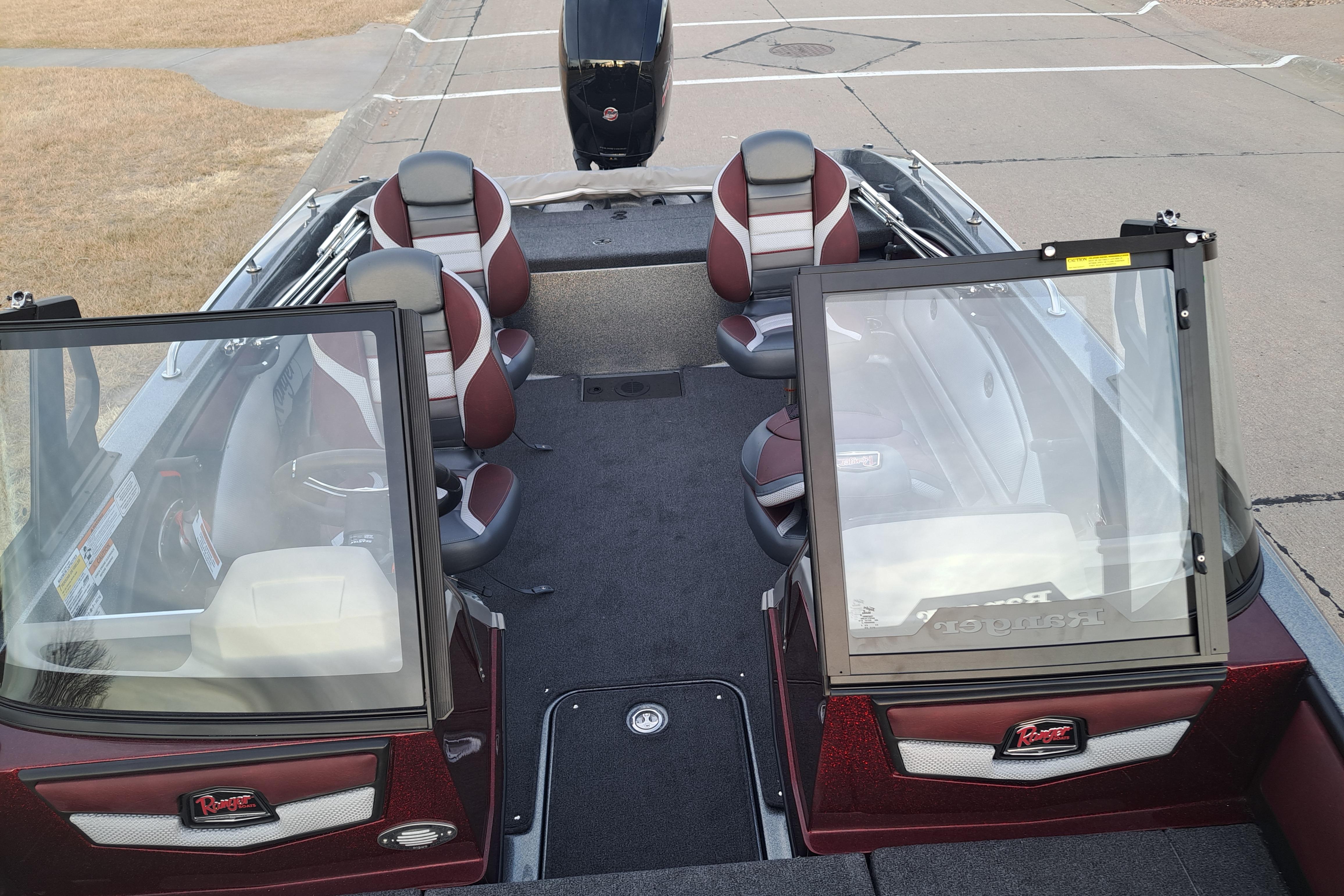2026 Ranger 1850MS boat interior with seating and windshield, parked on pavement.