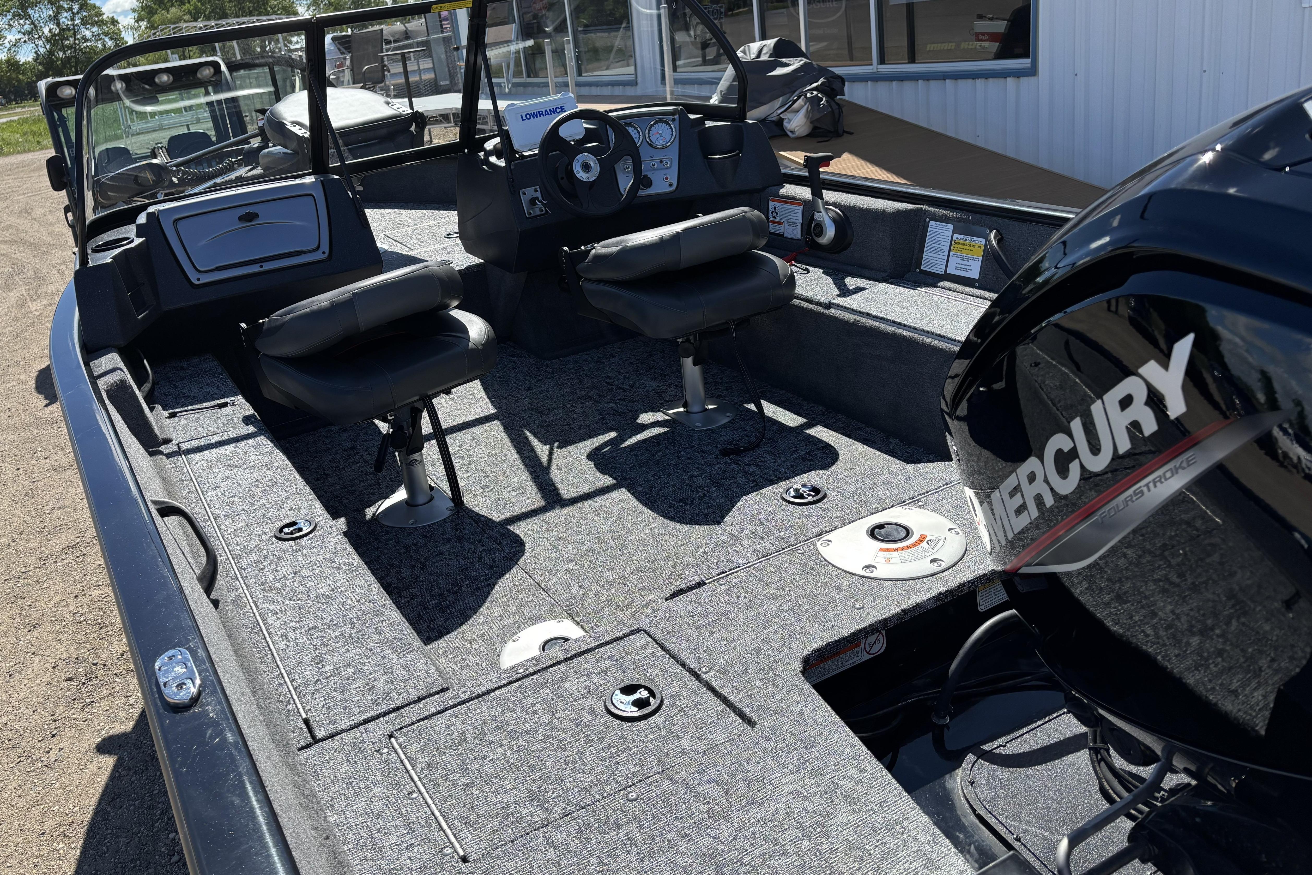 2026 Tracker Pro Guide V-16 WT boat interior with Mercury engine, featuring dual seats and control panel.