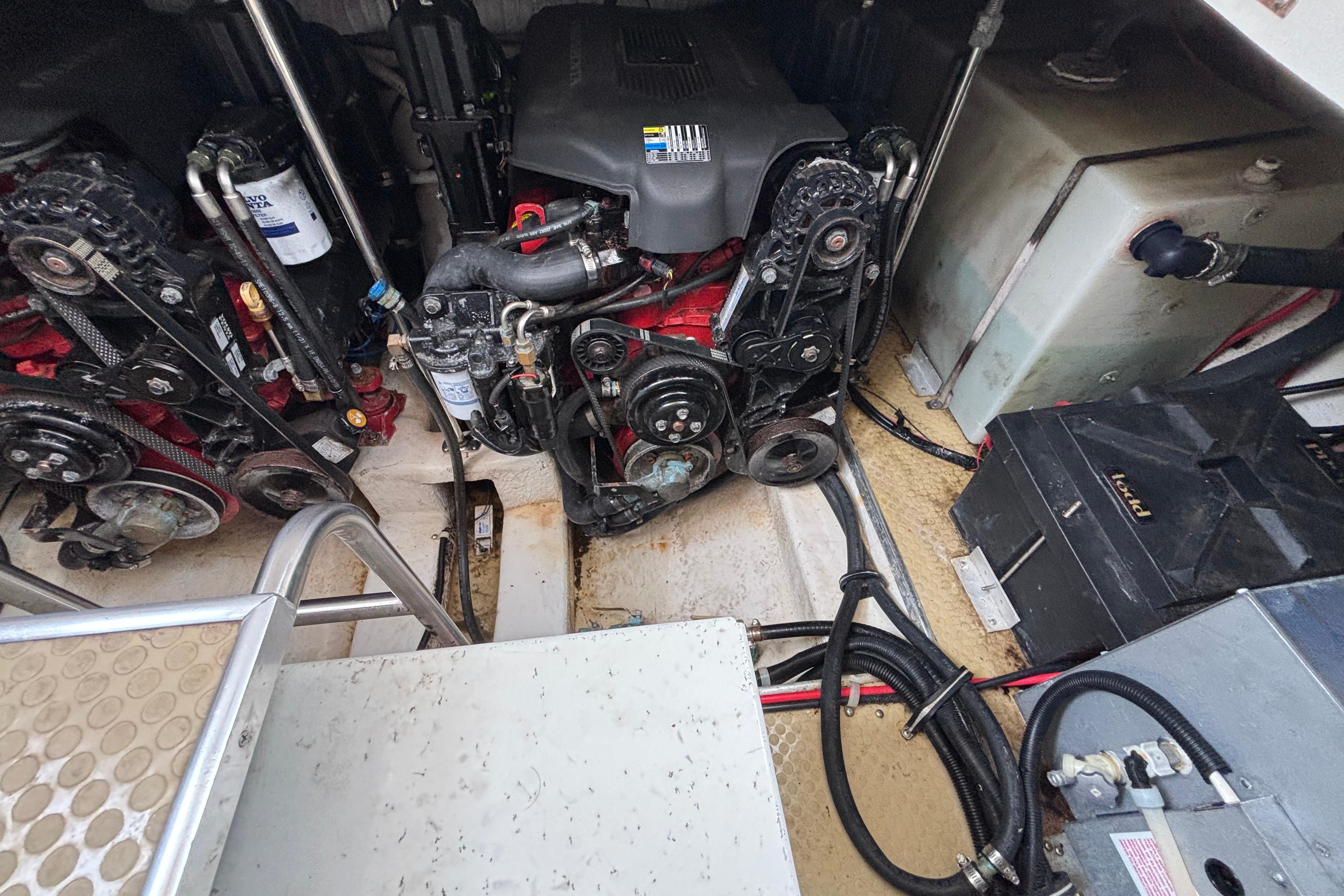 Engine compartment of a 2004 Larson 310 boat, showing dual engines and mechanical components.
