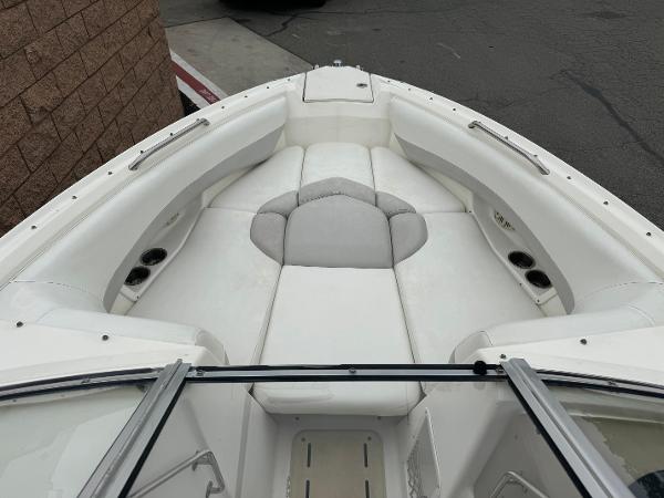 2006 Larson LXi 248 boat interior with white seating and cup holders.