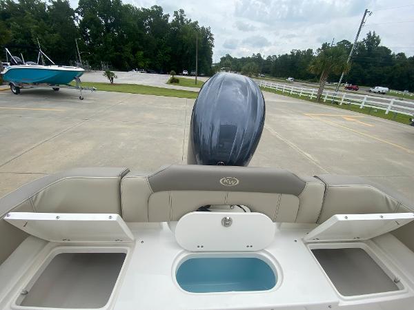 2024 Key West 203 FS boat stern with storage compartments and outboard motor.