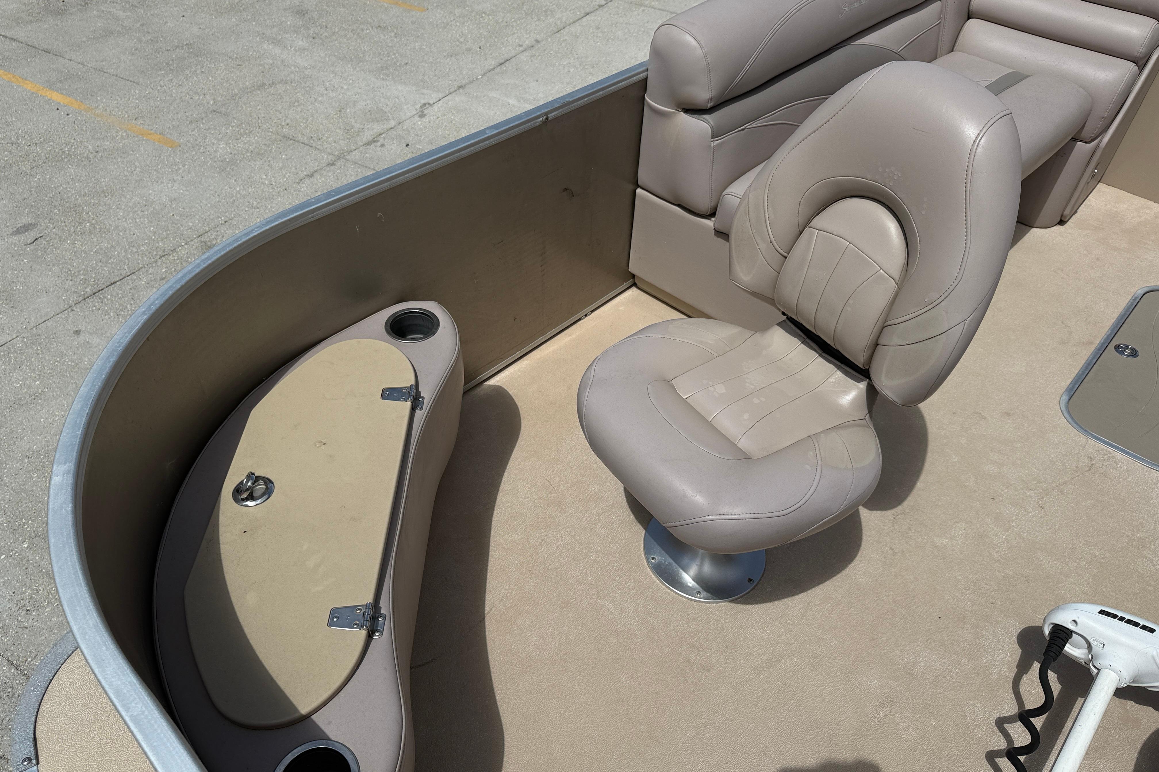 2014 Godfrey Sweetwater 2486 C boat interior with beige seating and storage compartment.