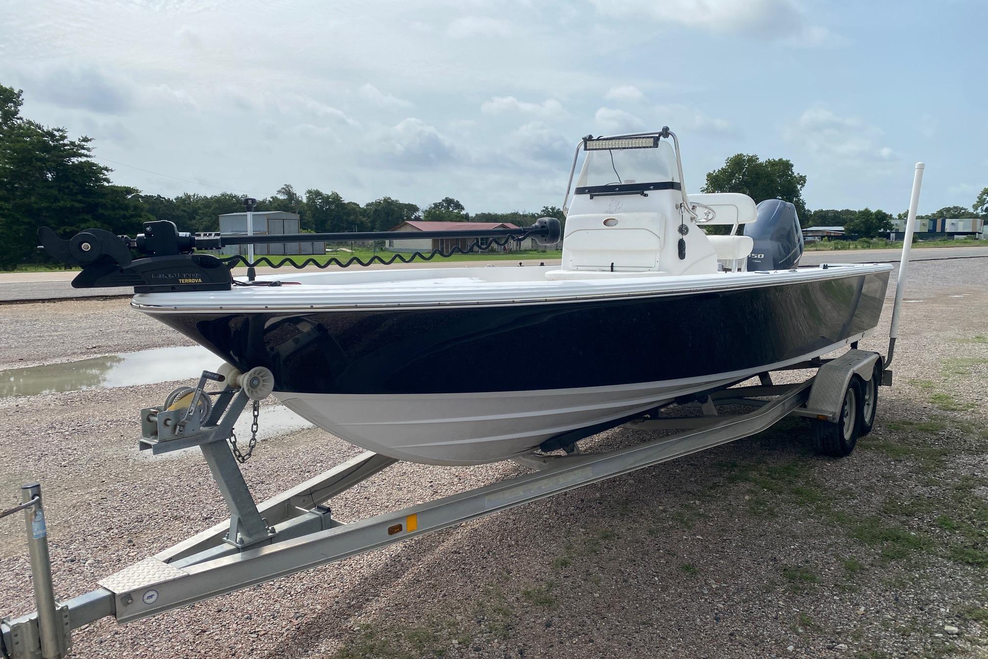 2013 Sportsman Masters 227 Bay Boat on trailer, parked outdoors.