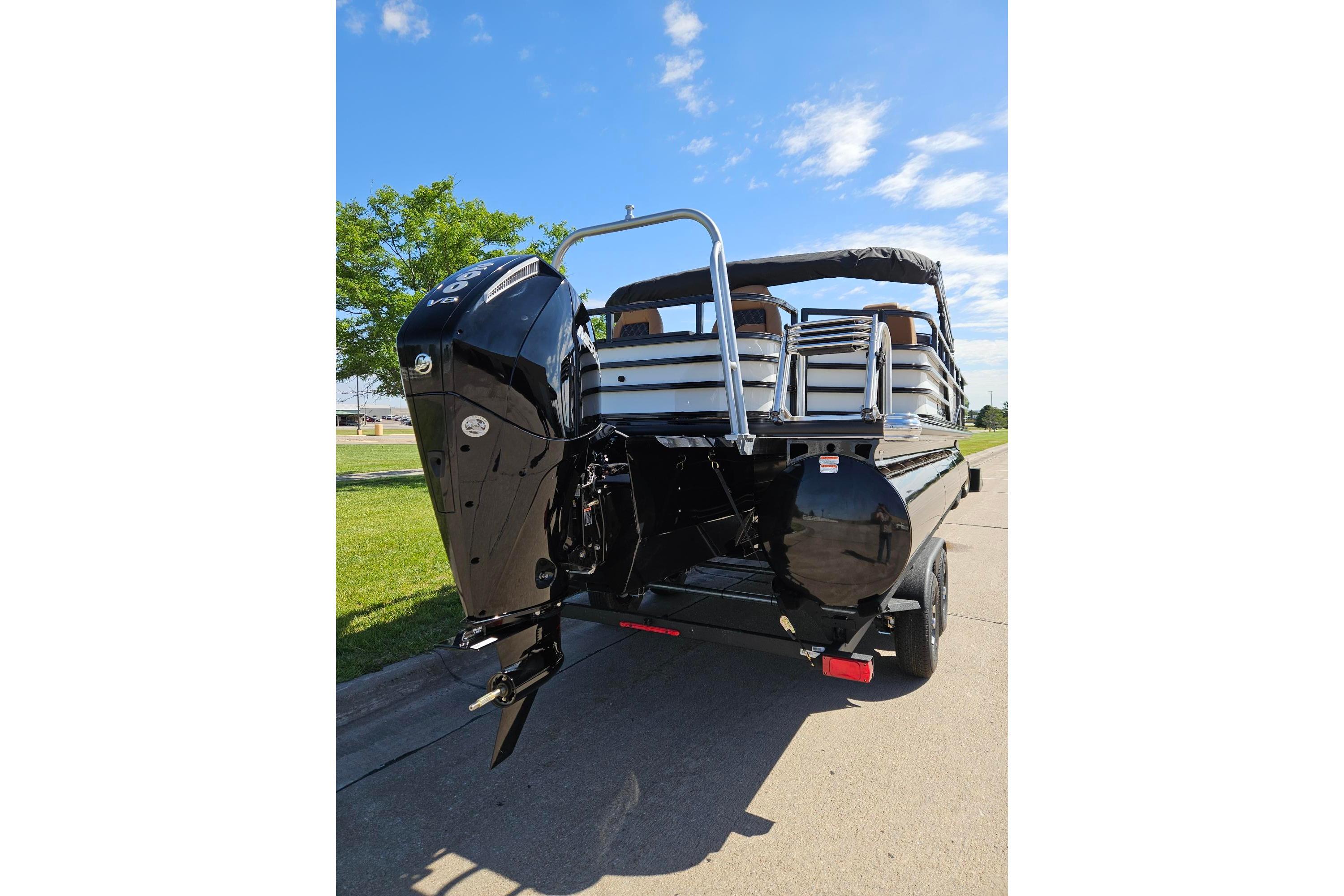 2026 Ranger 223F boat with powerful outboard motor on a sunny day.