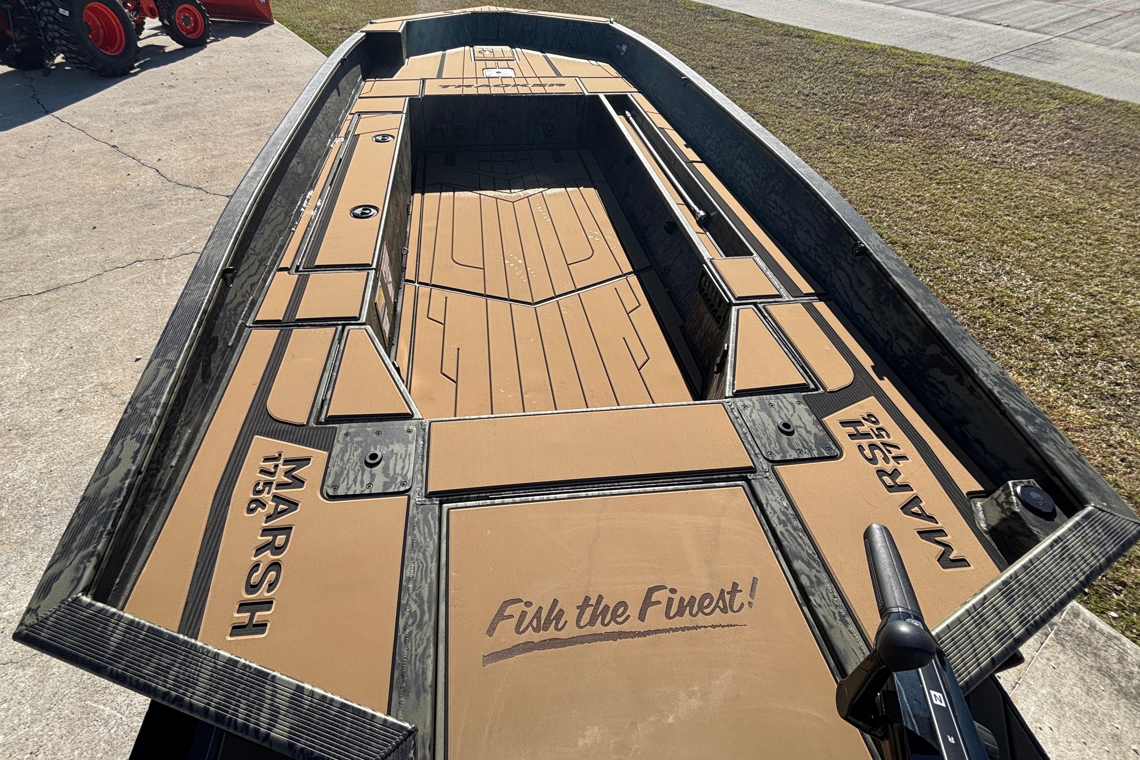 2026 Tracker Grizzly 1756 T Marsh boat with custom deck design, "Fish the Finest" slogan.