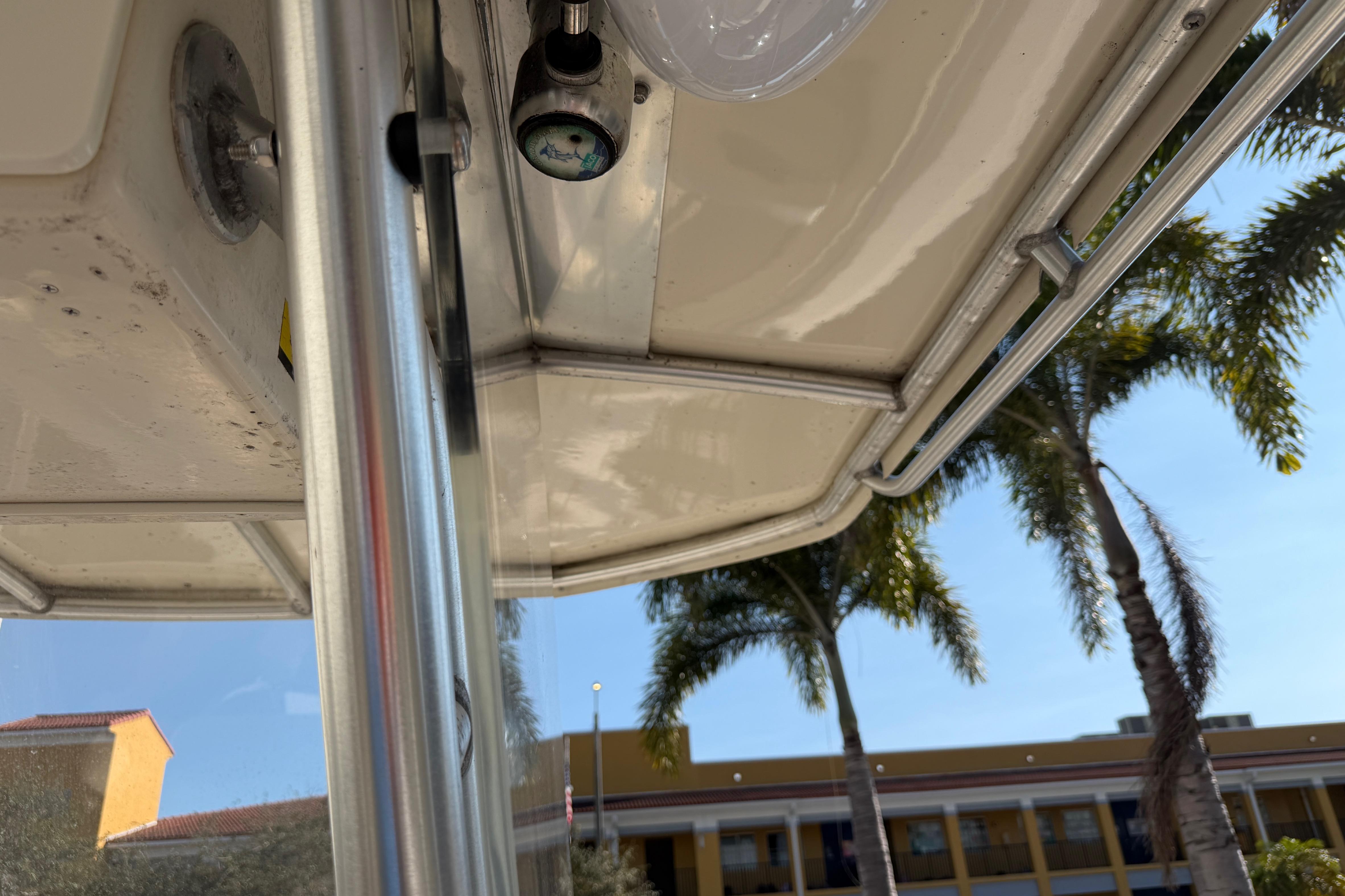 2004 Grady White 273 boat interior with palm trees in the background.