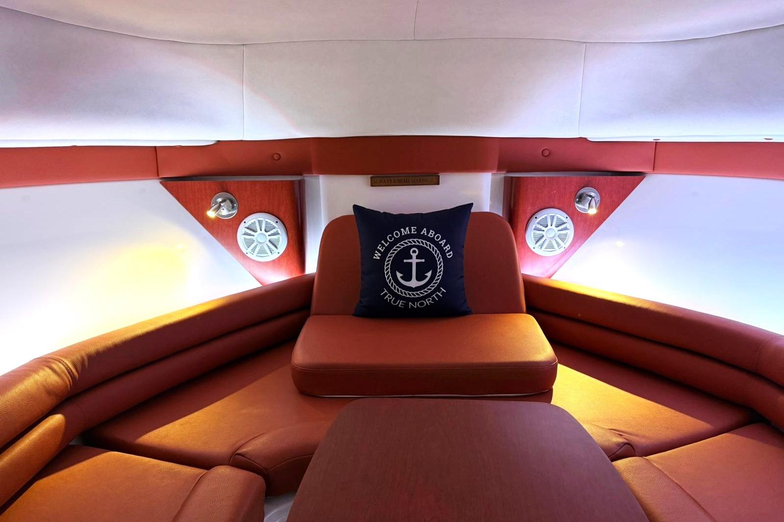 Luxurious interior of 2006 Pro-Line 32 Express boat with cozy seating and nautical decor.