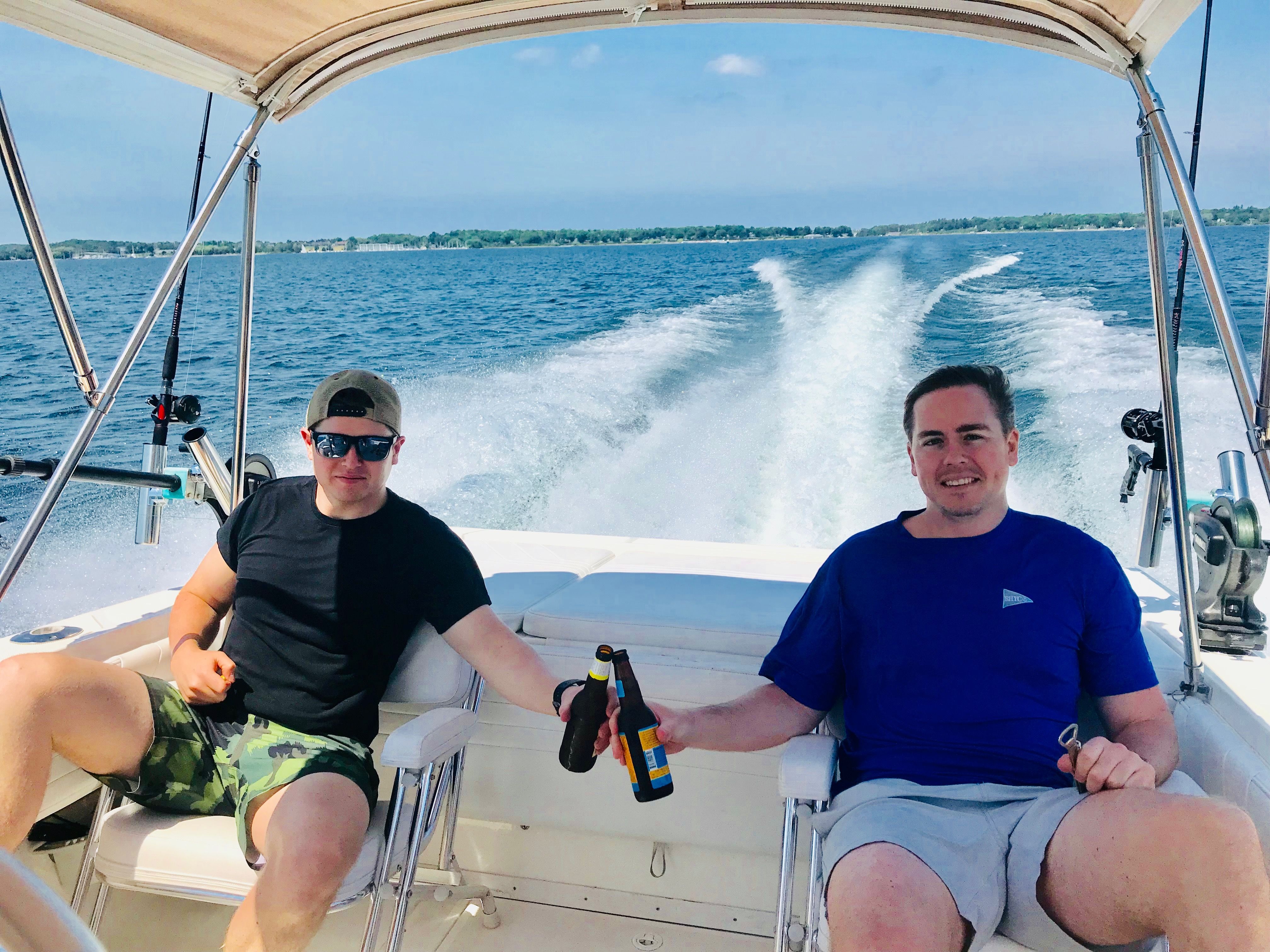 Two men relaxing on a 1999 Fountain 32 Sport Fish Cruiser.