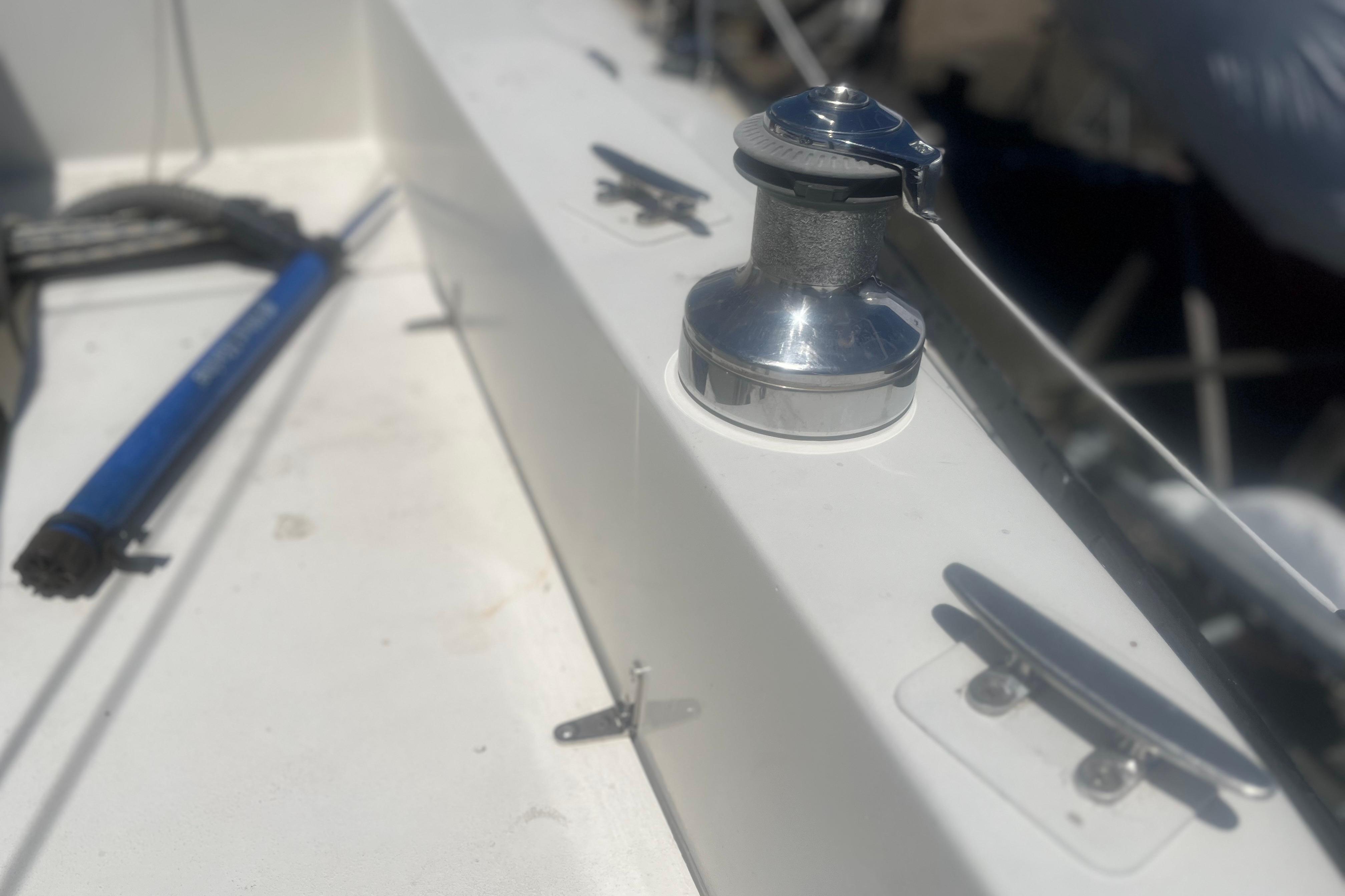 Deck of a 1972 C&C 30 sailboat featuring a winch and cleat.