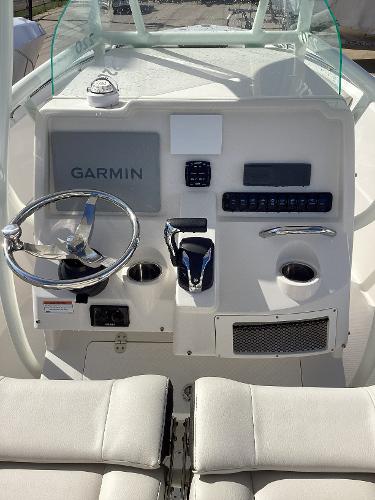 2022 Sailfish 220 CC boat dashboard with Garmin navigation system and steering wheel.