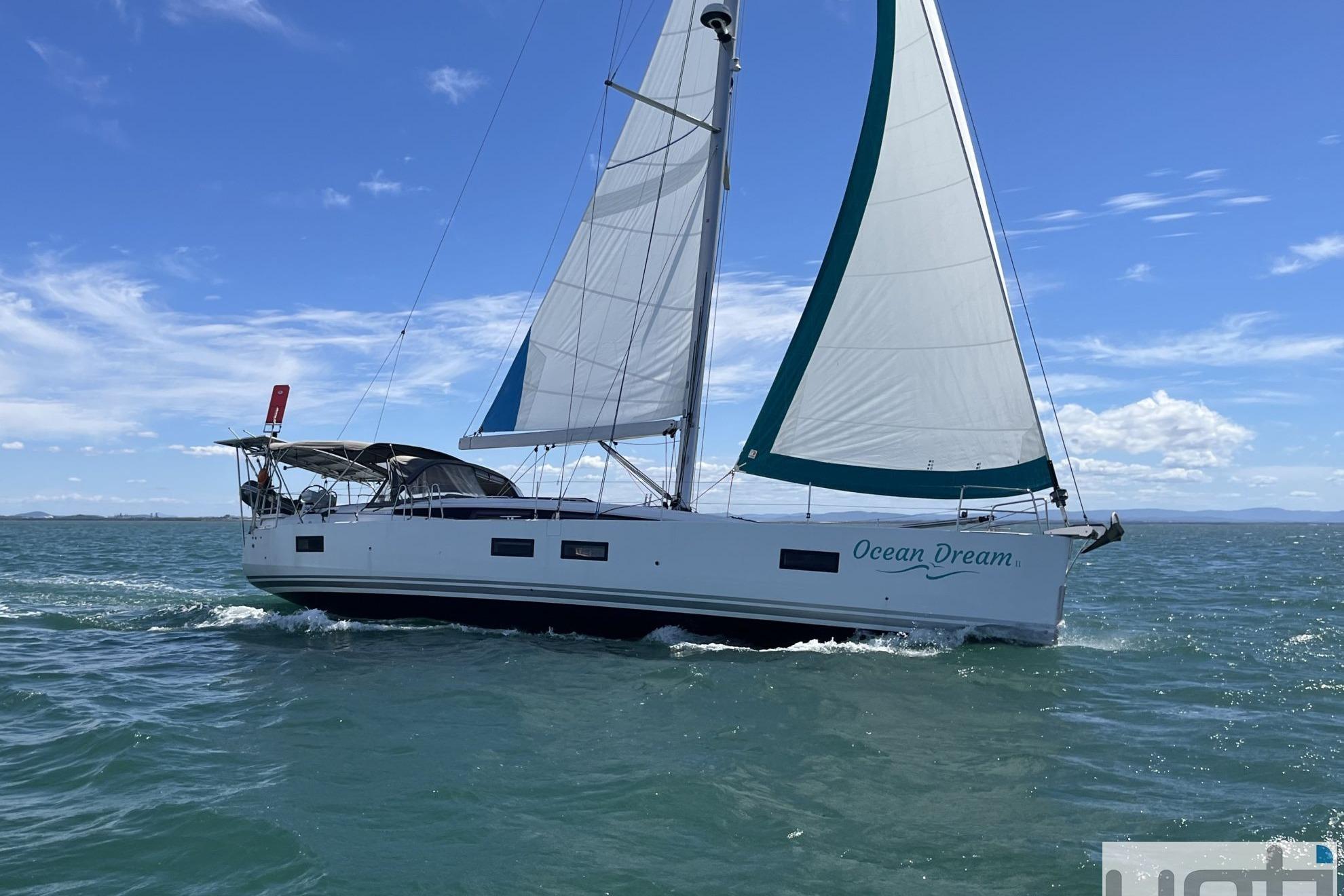 2019 Jeanneau 51 sailboat "Ocean Dream" cruising on open water under clear skies.