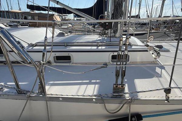 Sailboat deck of 2011 Reliance 44, featuring rigging and marina background.