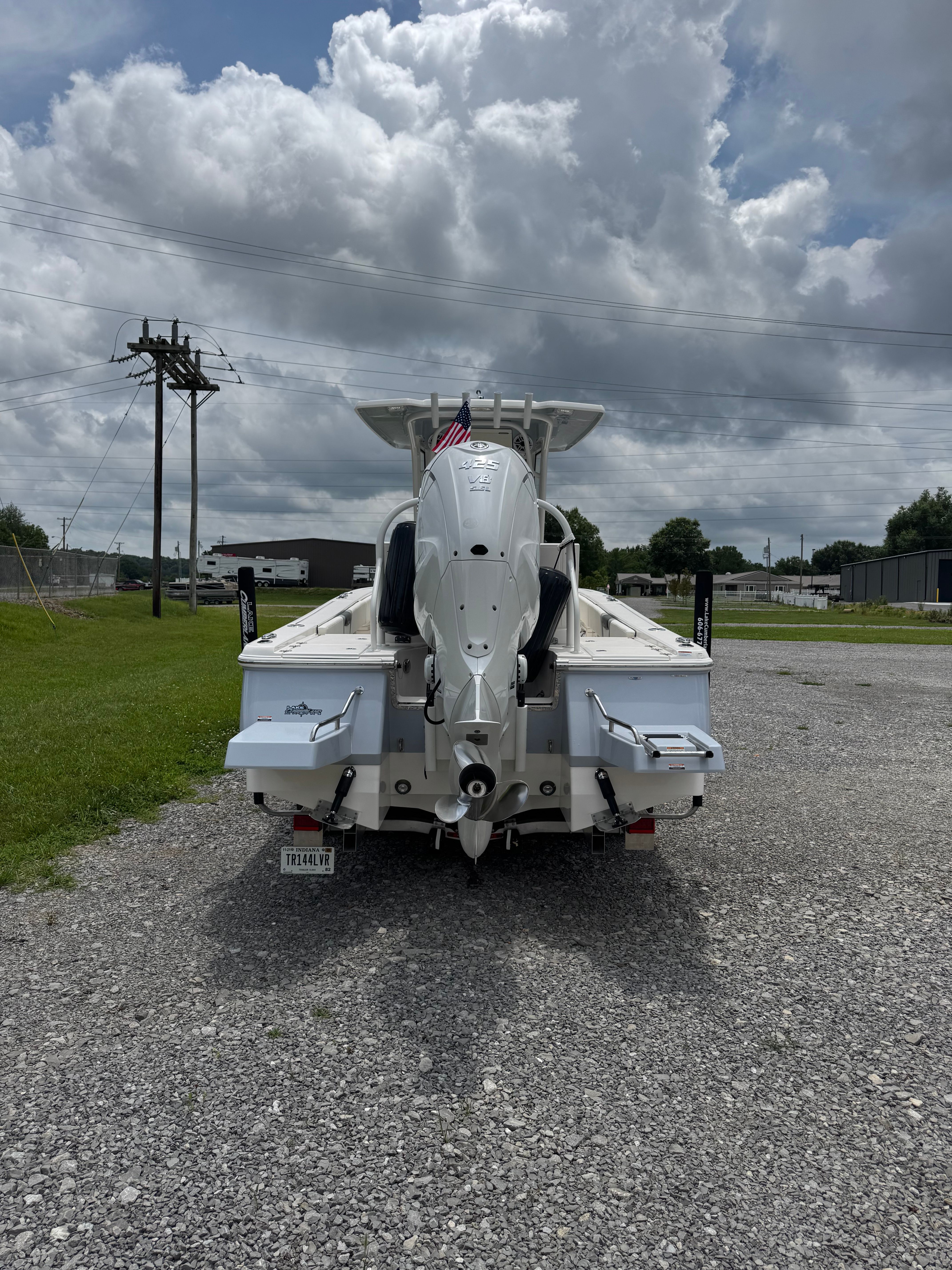 The image shows a 2023 Robalo 266 Cayman boat on a gravel lot. It features an outboard motor.