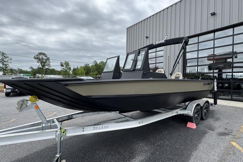 2026 SeaArk Predator 300 AK boat on trailer outside a modern building.