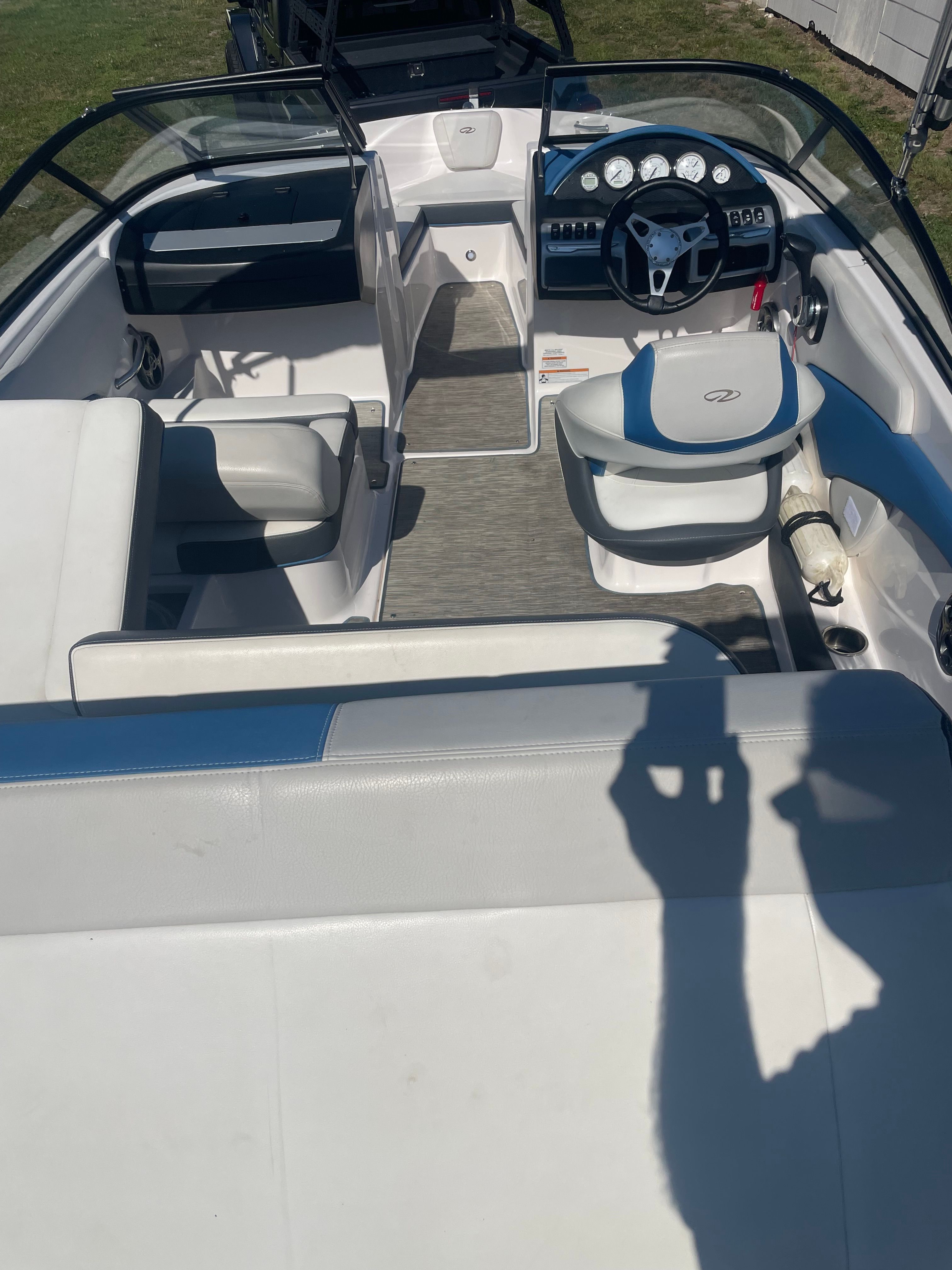 Interior view of a 2016 Regal 1900 ESX Bowrider with white and blue seating.