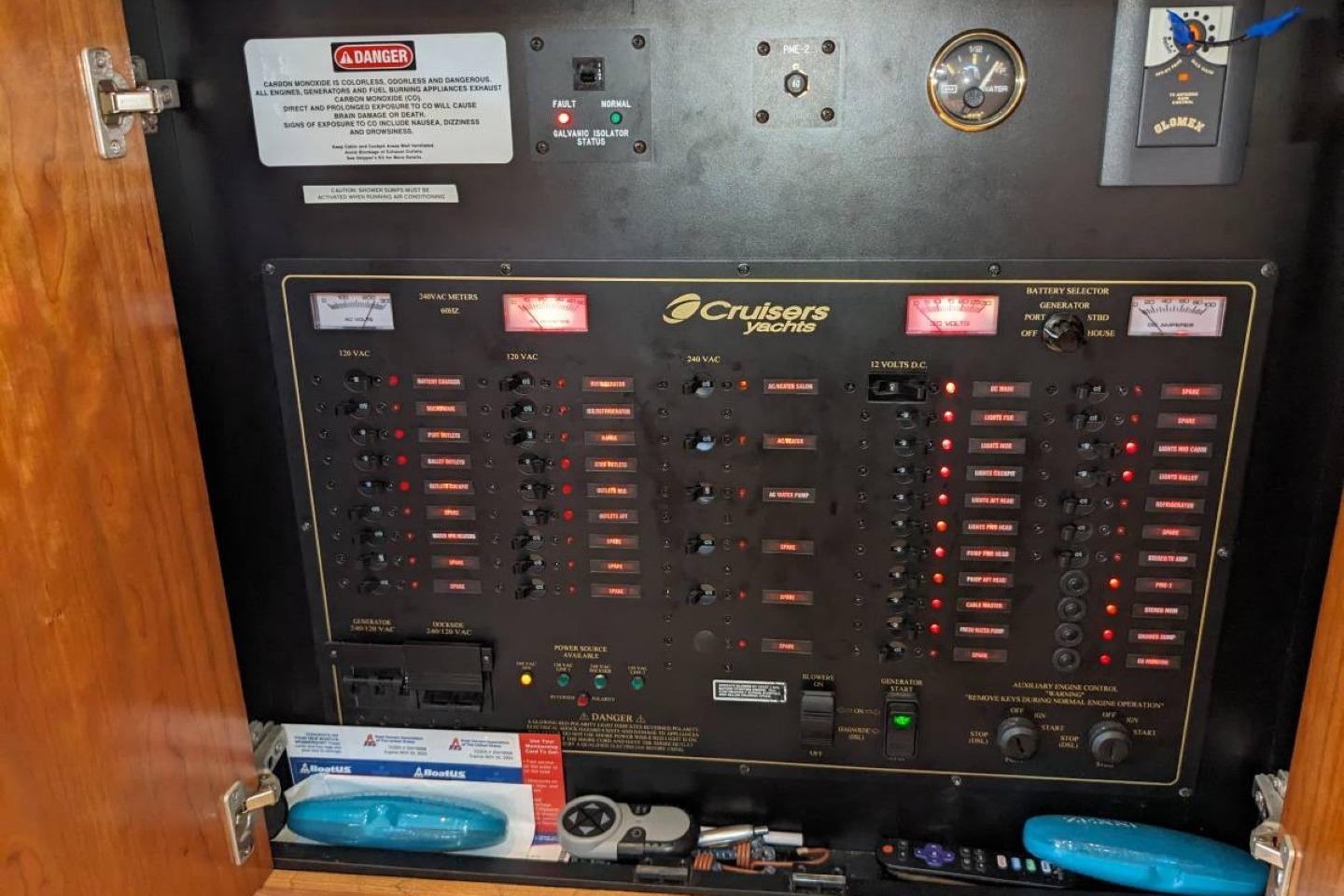 Electrical control panel of a 2003 Cruisers 3970 yacht with various switches and meters.