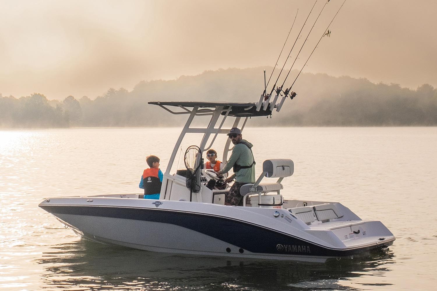 Manufacturer Provided Image: 2026 Yamaha Boats 195 FSH Sport on serene lake with passengers, fishing rods visible.