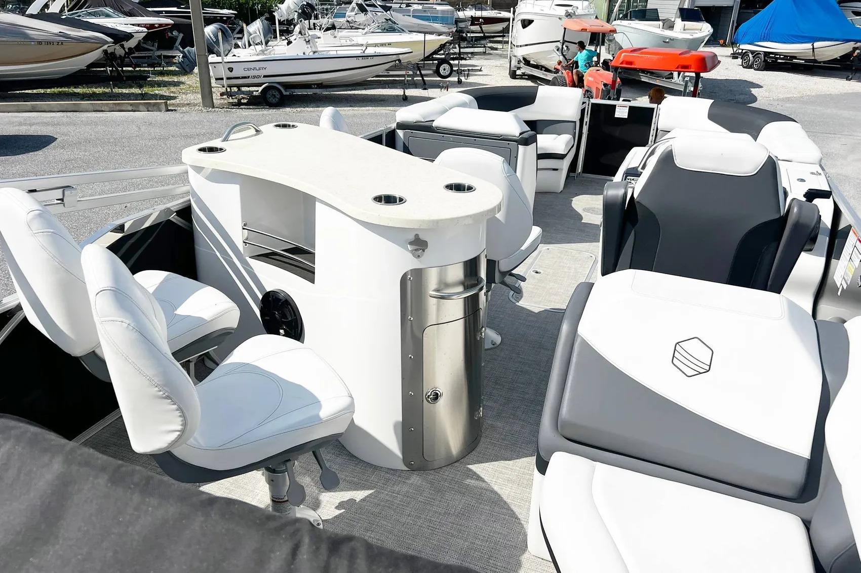 2023 South Bay 523 R pontoon boat interior with seating and table setup.