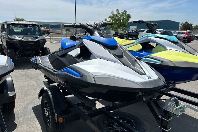 A Yamaha WaveRunner Jetblaster in black and blue on a trailer in a parking lot.