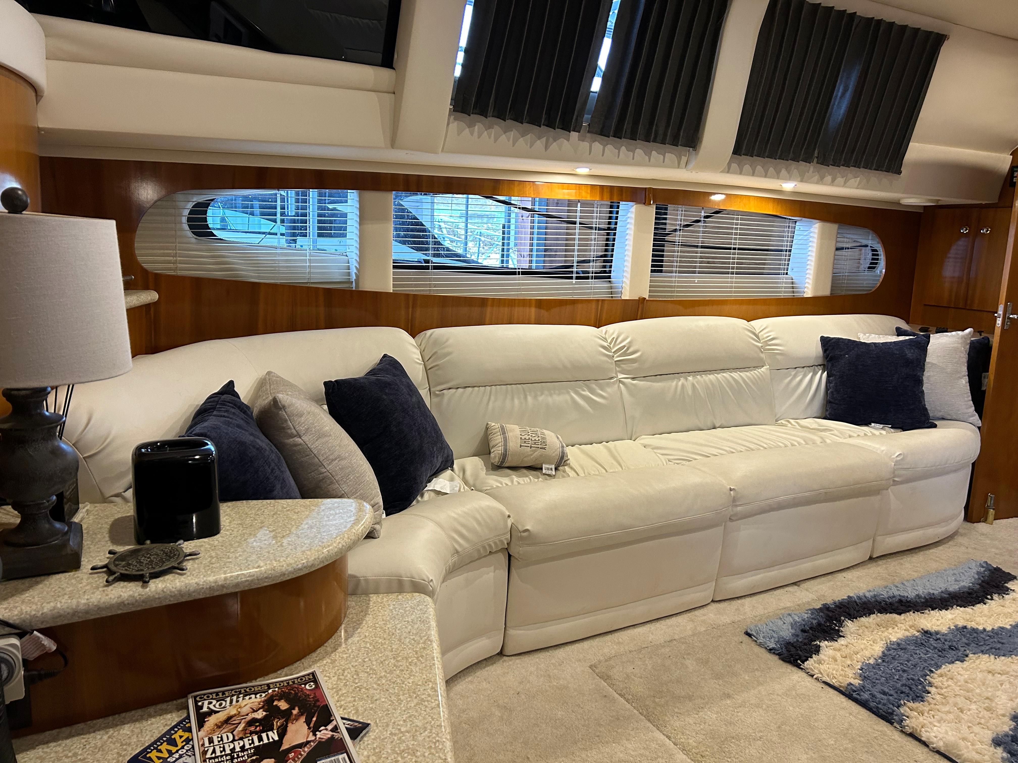 Luxurious interior of a 2000 Carver 396 yacht with white leather seating and elegant decor.