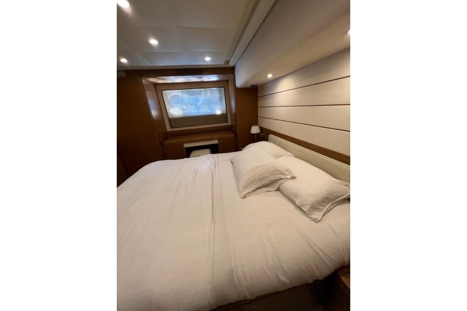 Luxurious bedroom interior of 2008 Apreamare Maestro 65 yacht with cozy bedding.