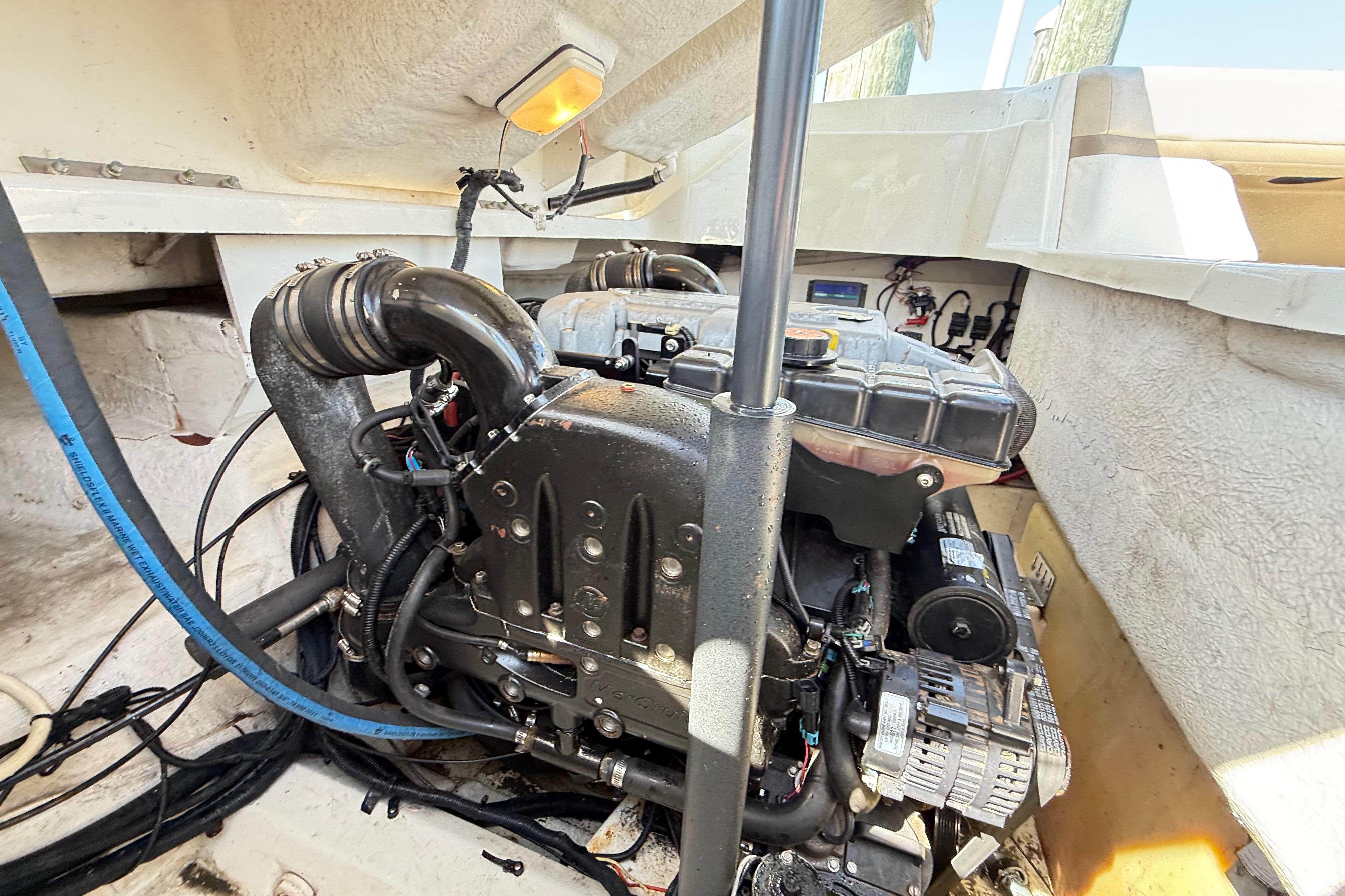 Engine compartment of a 2011 Sea Ray 270 SLX boat, showcasing mechanical components.