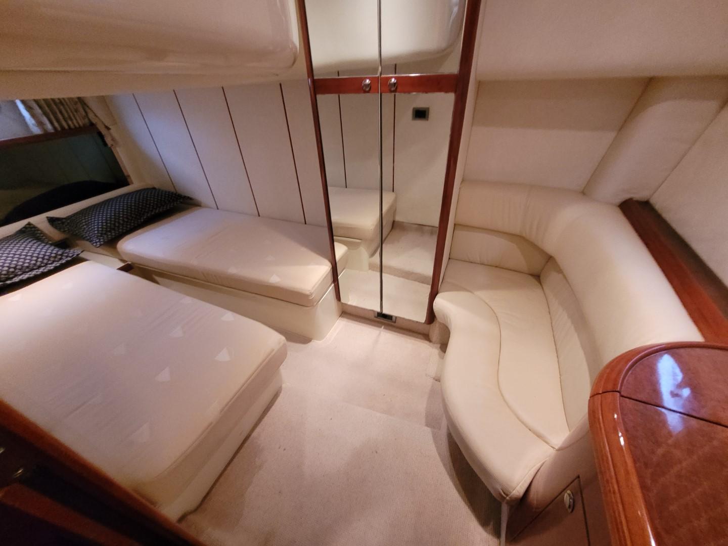 2004 Fairline Targa 43 yacht interior with cozy seating and mirrored storage.