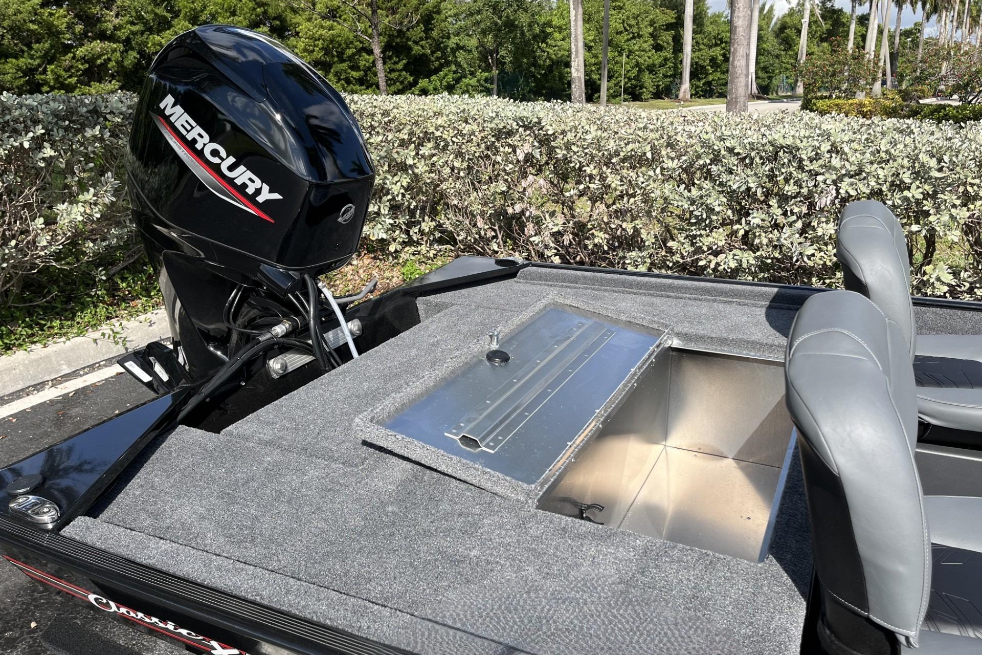 2026 Tracker Bass Tracker Classic XL boat with Mercury engine, open storage compartment.
