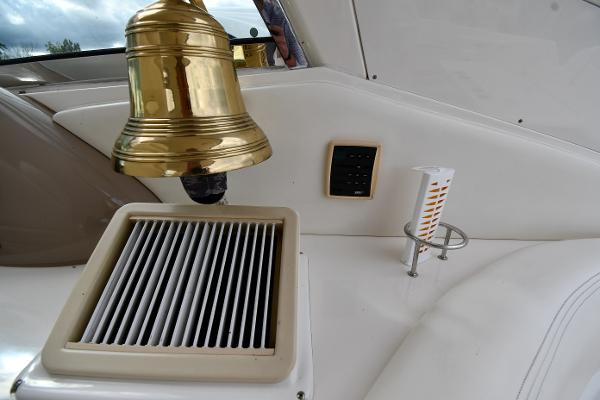 2003 Sea Ray 460 Sundancer interior with brass bell and ventilation grille.