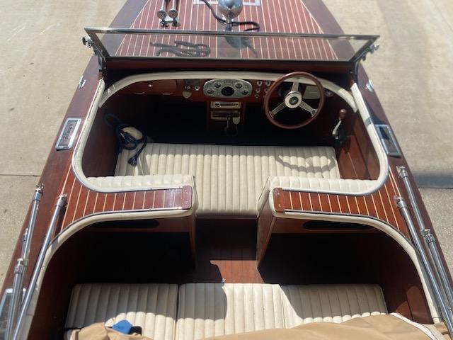 Grand Craft Classic Runabout 2000, vintage wooden boat interior with steering wheel and seating.