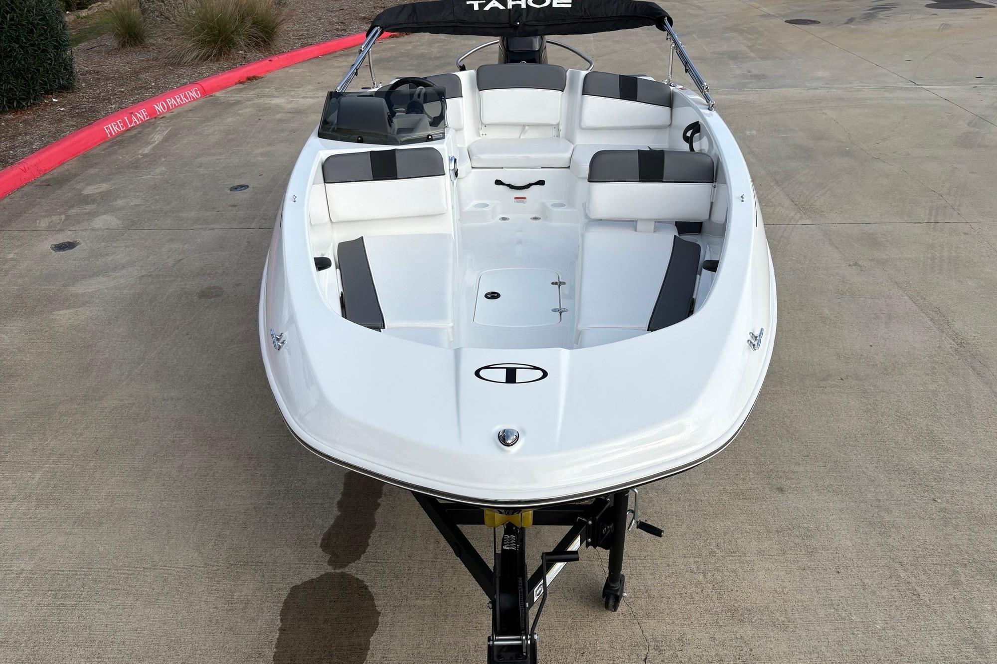 2025 Tahoe T16 boat on trailer, white exterior, black and white seating.