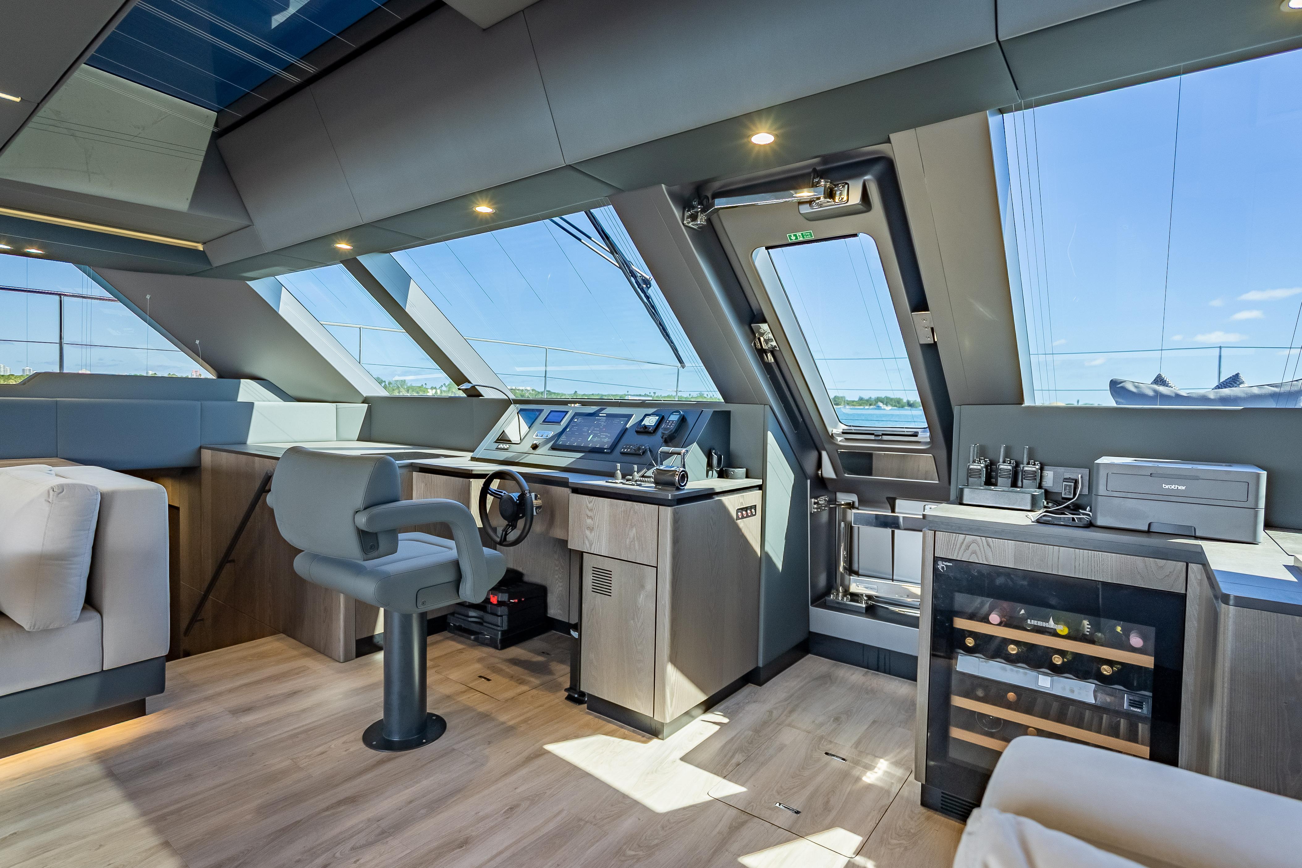 Luxurious interior of 2026 Sunreef 60 Power yacht with modern helm and panoramic windows.