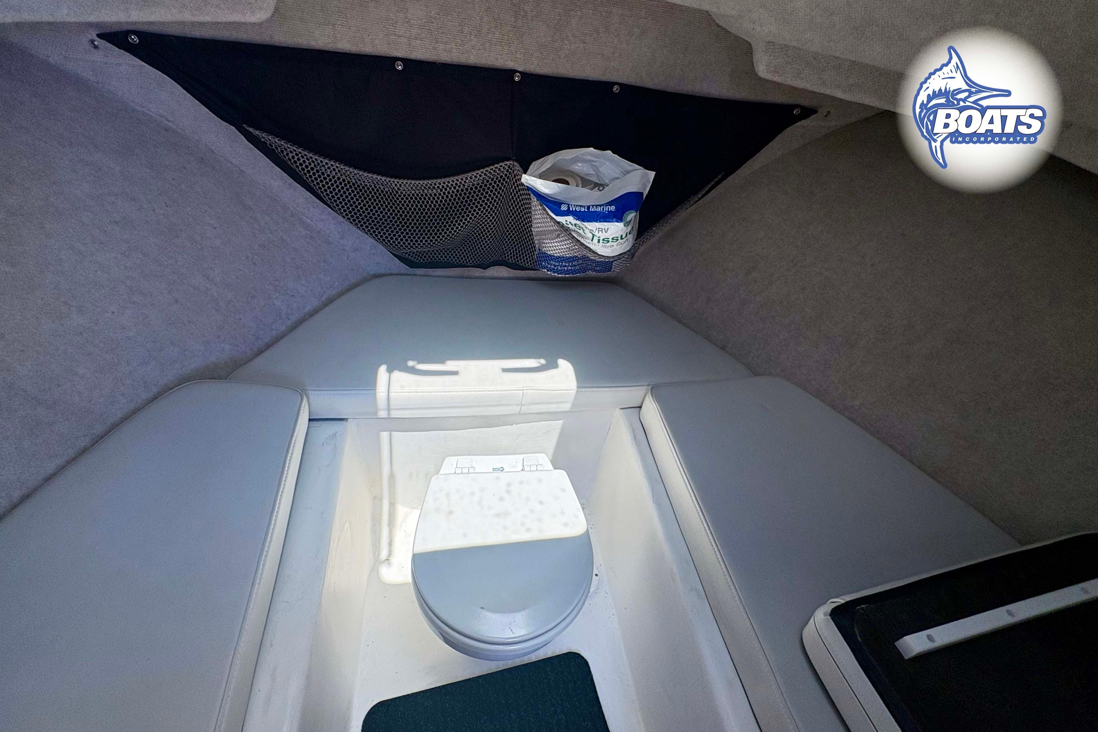 2021 Parker 2520 XLD Sport Cabin interior with compact marine toilet and storage.