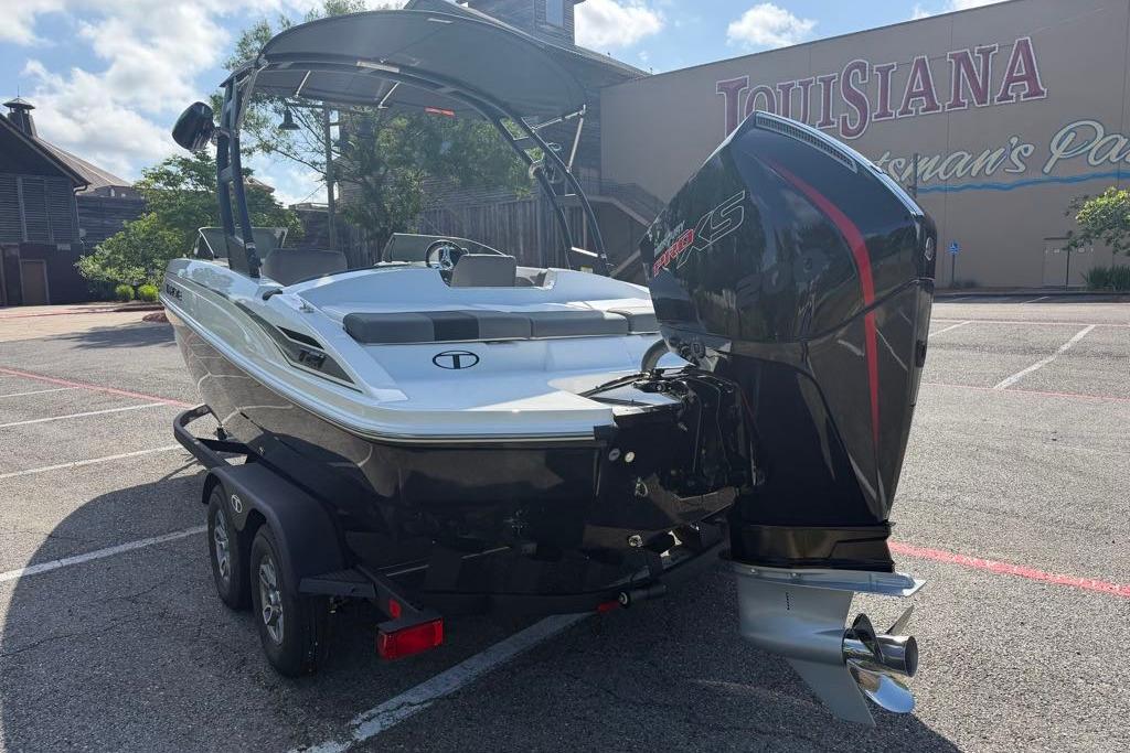 2026 Tahoe T21 boat with powerful outboard motor in a parking lot.