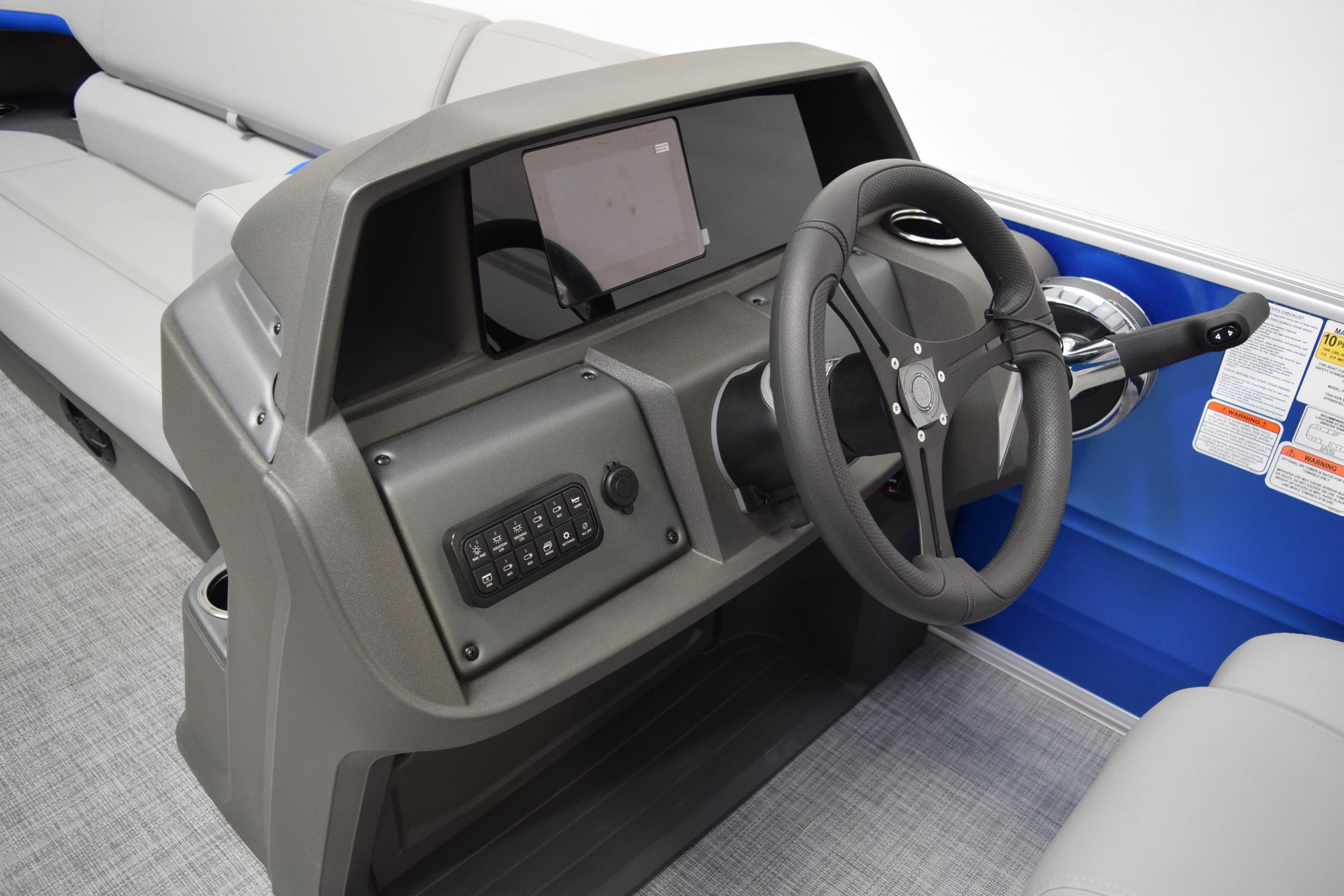 2026 Sun Tracker Party Barge 20 DLX helm with steering wheel and control panel.