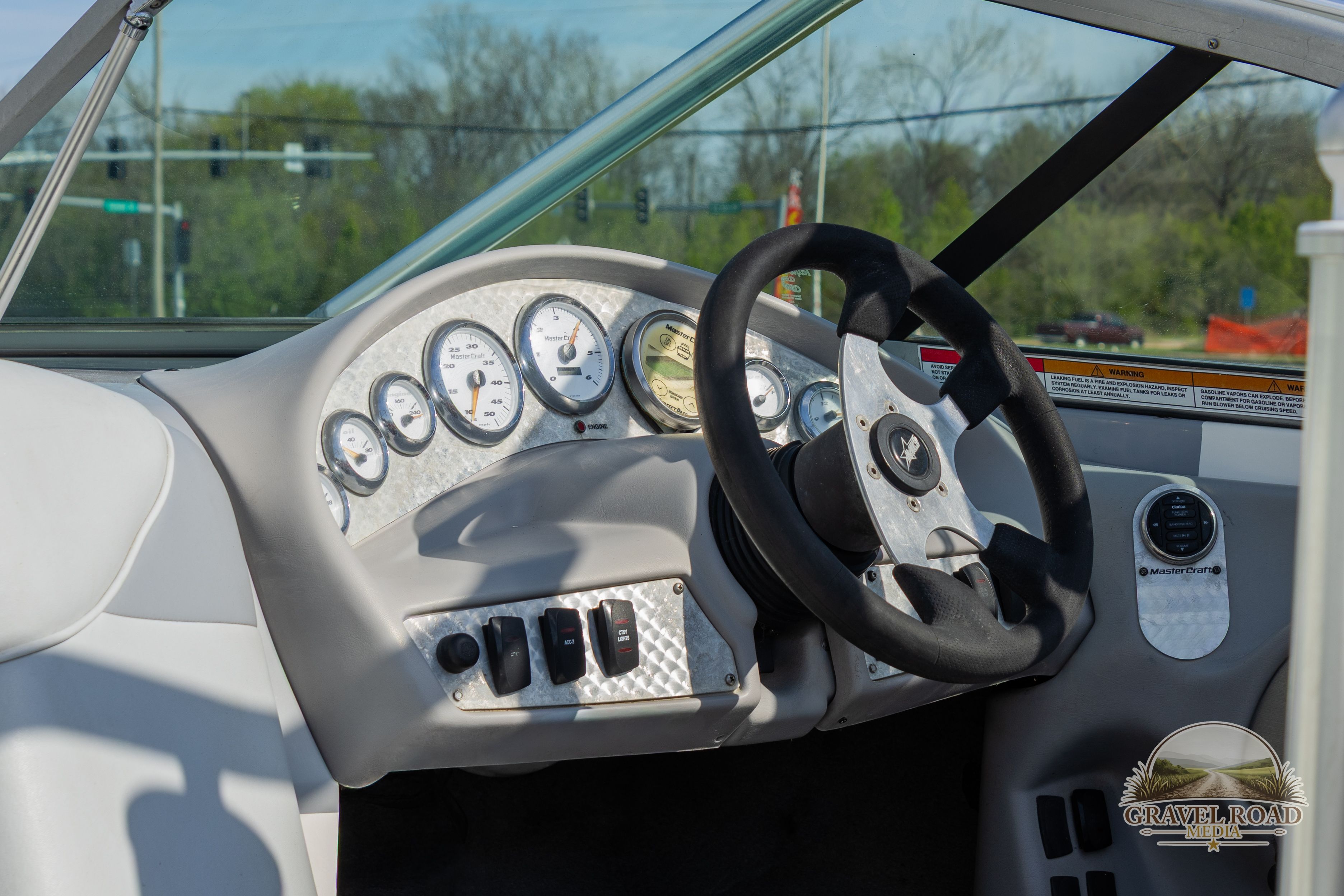 Dashboard of a 2002 MasterCraft X-7 boat with steering wheel and gauges.